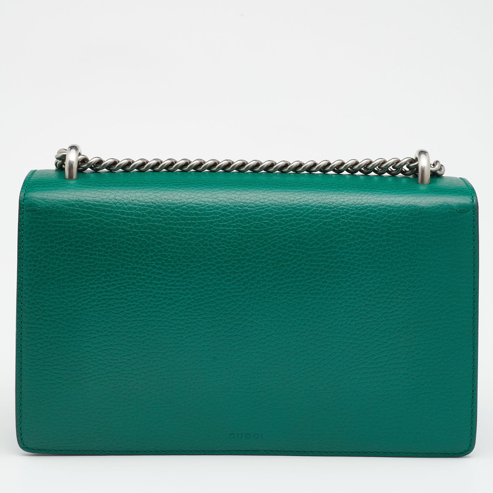 Gucci's Dionysus collection is inspired by the Greek God who is believed to have crossed the Tigris river on a tiger given to him by his father, Zeus. This creation has been beautifully made from leather in a green hue. The flap secures the interior