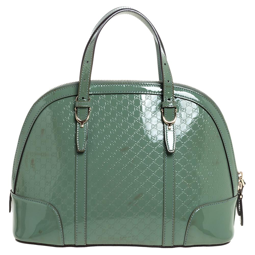 Meticulously crafted from Microguccissima patent leather, this Gucci bag delights not only with its appeal but structure as well. It is held by two top handles, detailed with gold-tone hardware, and equipped with a spacious canvas interior. The