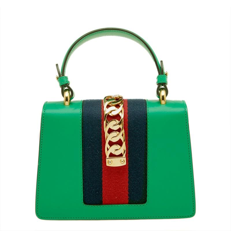 From the house of Gucci comes this gorgeous Sylvie shoulder bag that will perfectly complement all your outfits. It has been luxuriously crafted from leather and styled with a chain-web decorated flap and a buckle lock to secure the Alcantara