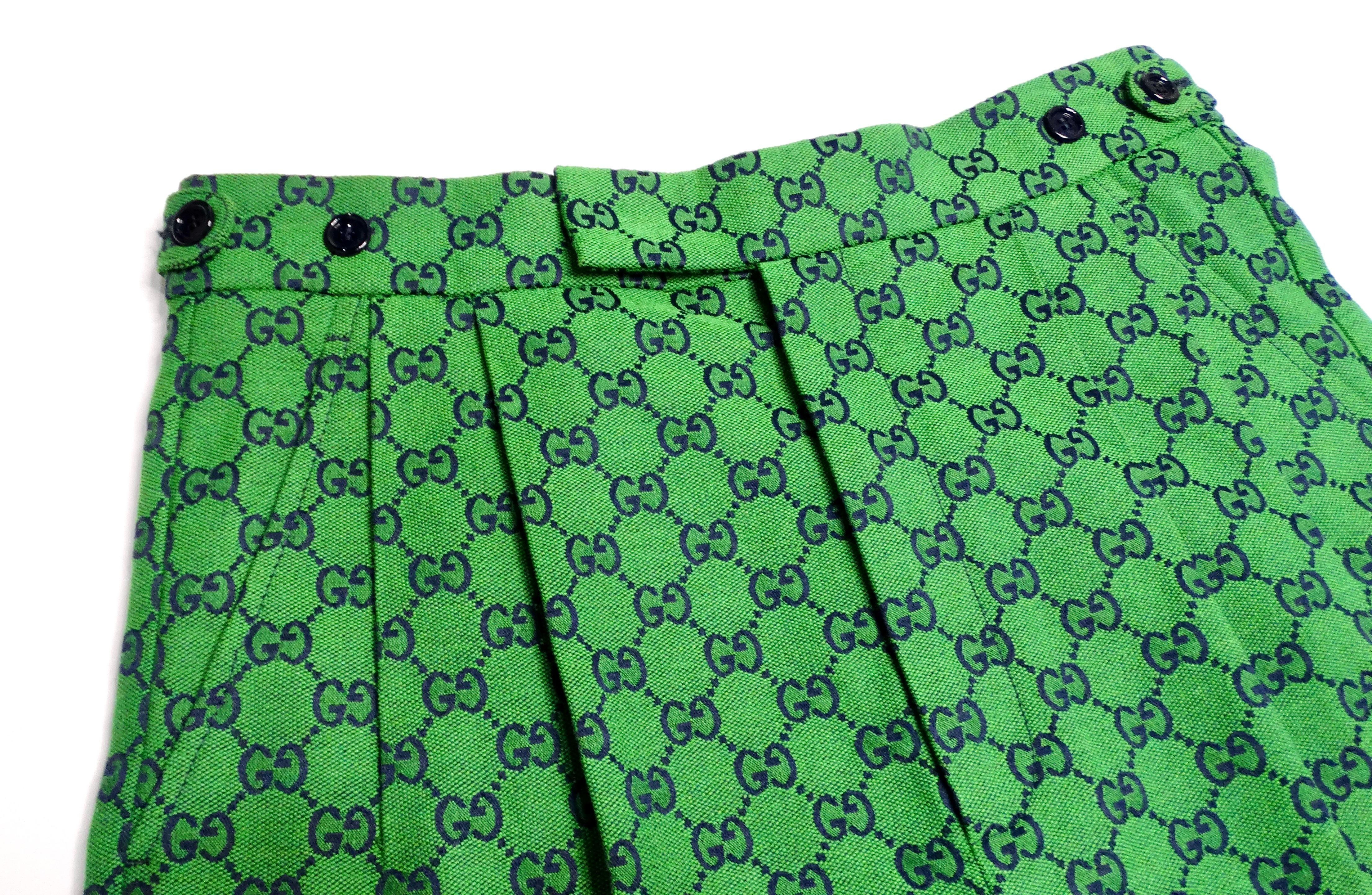 The Gucci Green Monogram High-Waisted Pleated Shorts epitomize luxury and sophistication, marrying contemporary design with classic elegance. Crafted in a rich green fabric adorned with the iconic black Gucci monogram, these shorts feature a