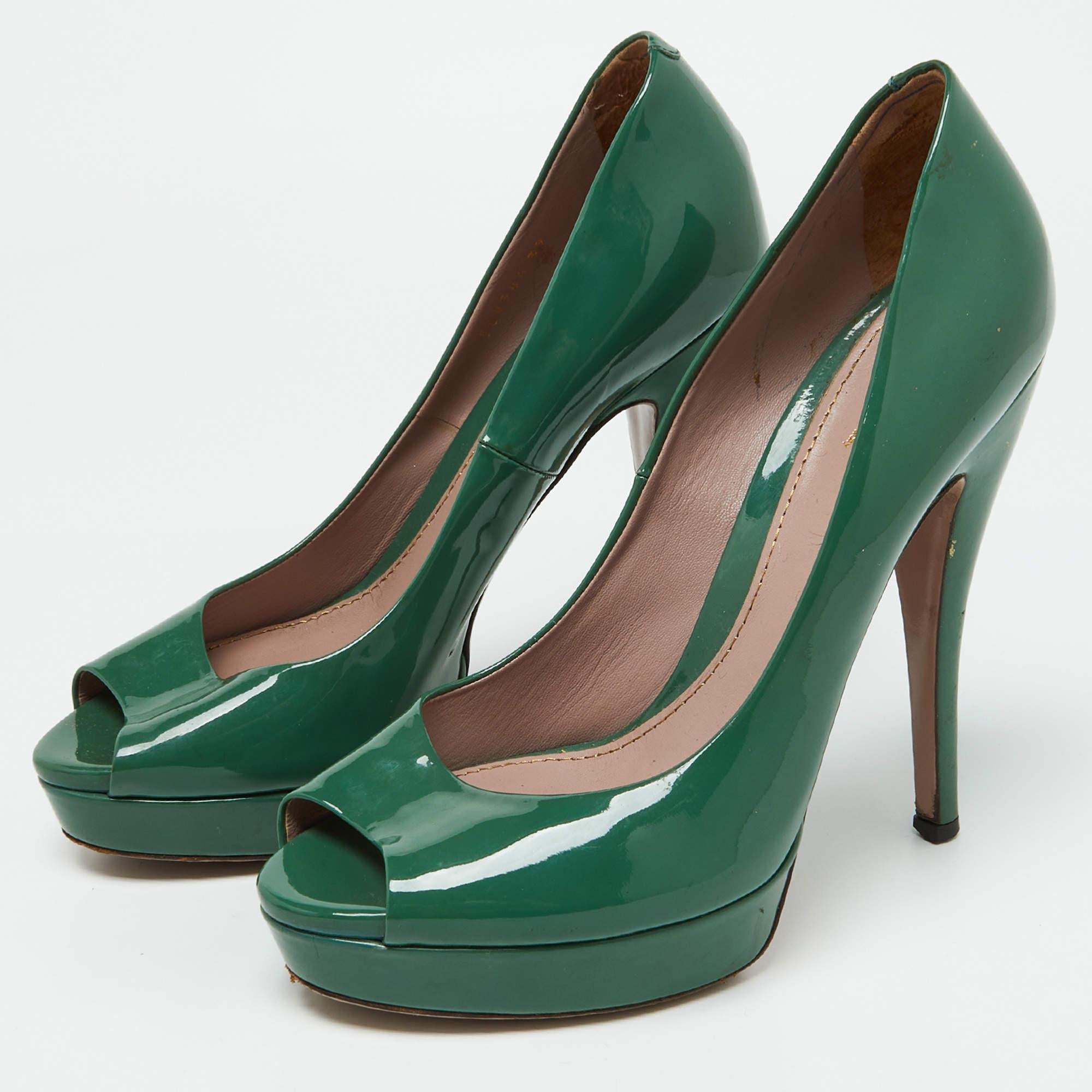 These stylish pumps come from the iconic house of Gucci. They are crafted from quality patent leather and come in a lovely shade of green. They are styled with peep toes platforms 14cm heels and leather soles.