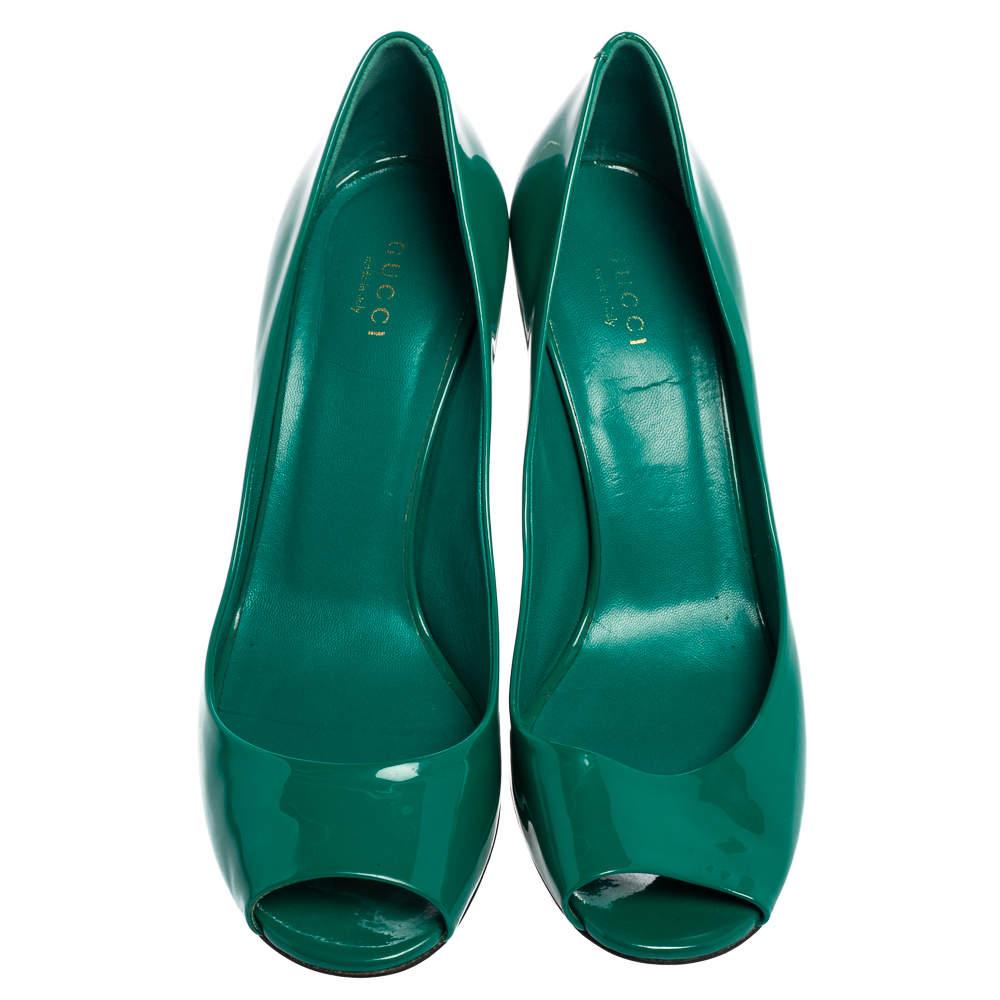 Crafted from patent leather on the exterior, this pair of Gucci pumps flaunts a peep-toe silhouette, finely-cut lines, and gold-tone hardware. Balanced on 8cm heels, it can even elevate your simple outfits.

Includes: Original Dustbag

