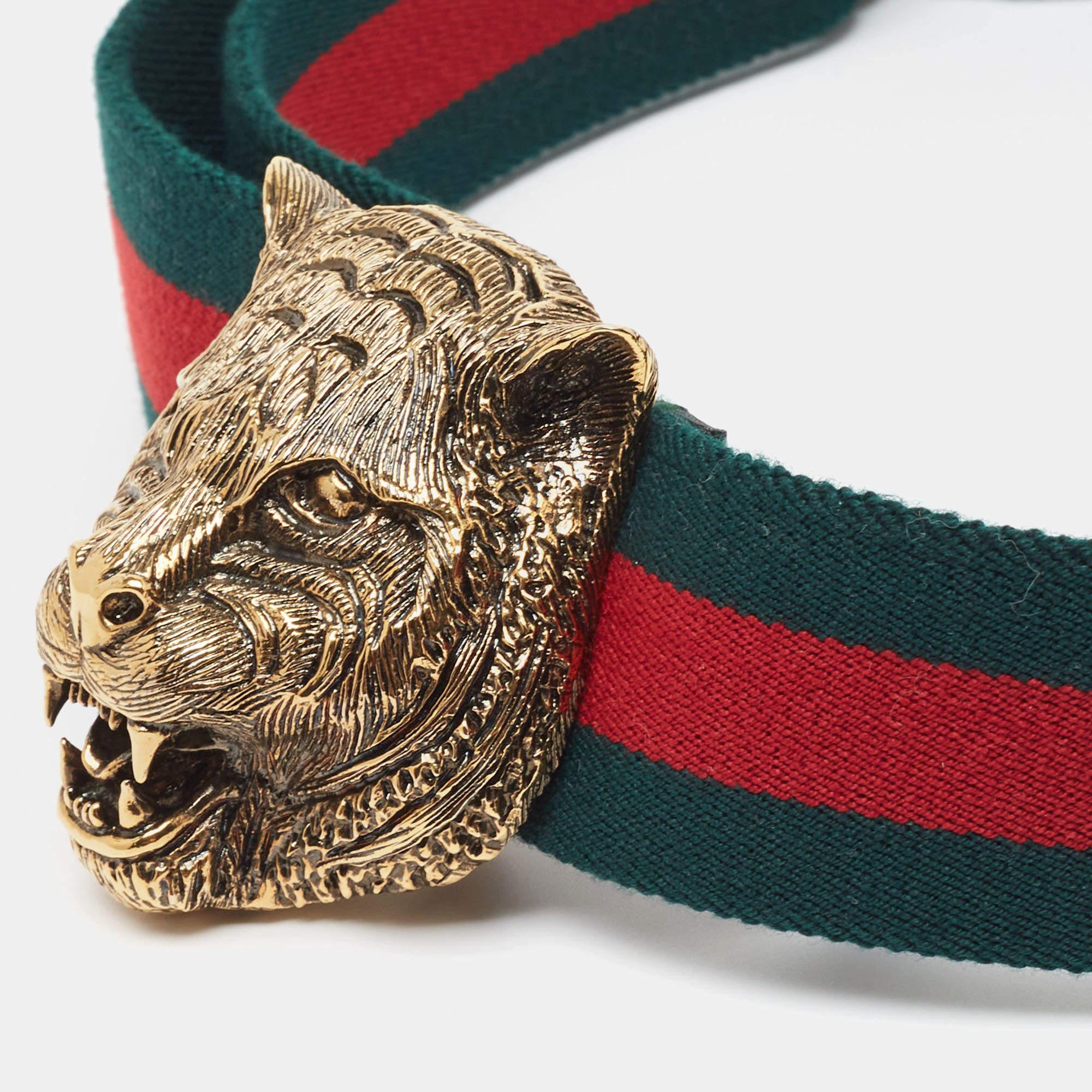 Experience the timeless allure of the Gucci belt. Crafted with meticulous attention to detail, this accessory boasts the iconic green and red web canvas strap, complemented by a striking feline buckle. It exudes refinement and adds a touch of luxury