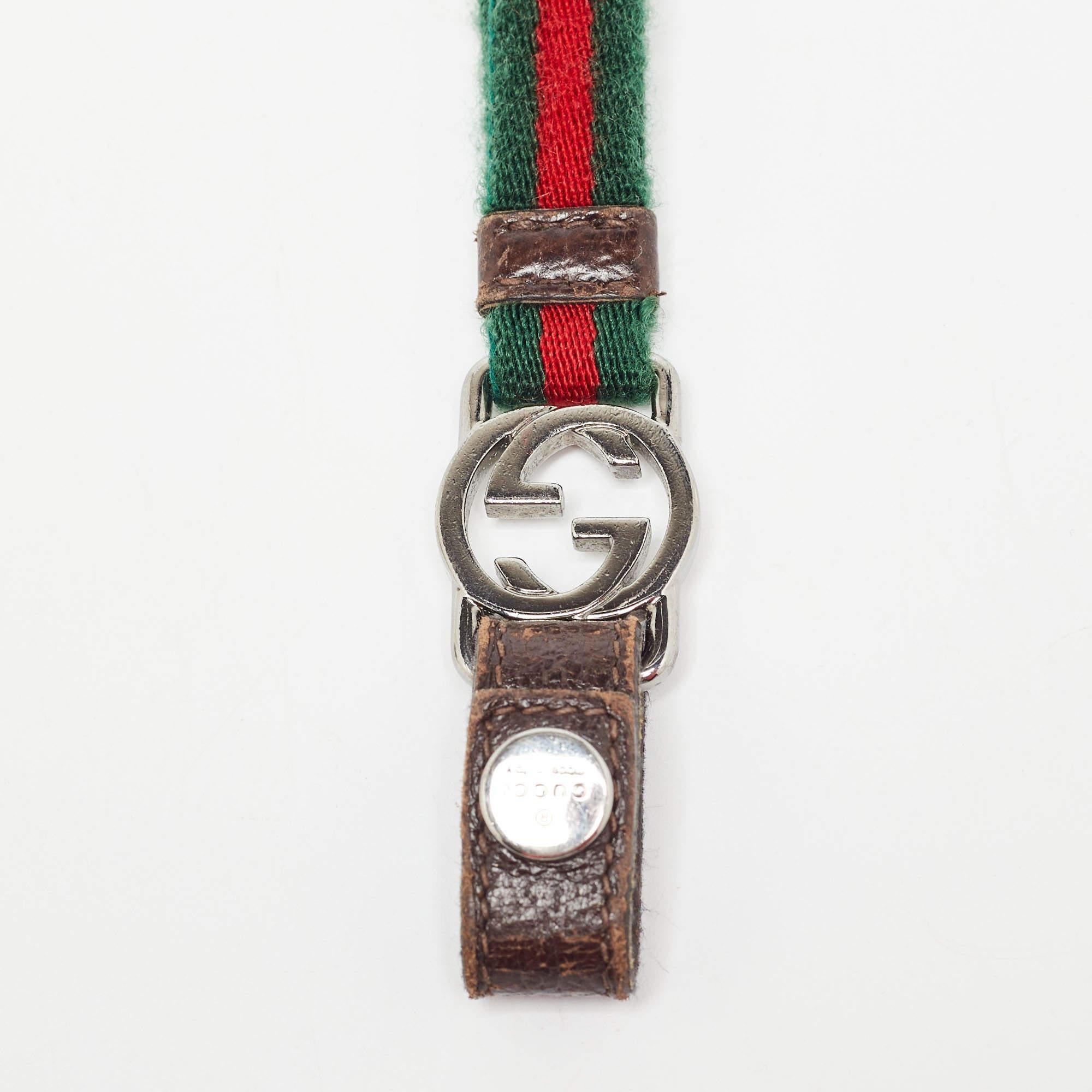 The Gucci lanyard keychain features iconic green and red stripes a sleek interlocking G charm and durable canvas construction. Perfect for adding a touch of luxury to your everyday essentials this stylish keychain combines functionality with classic