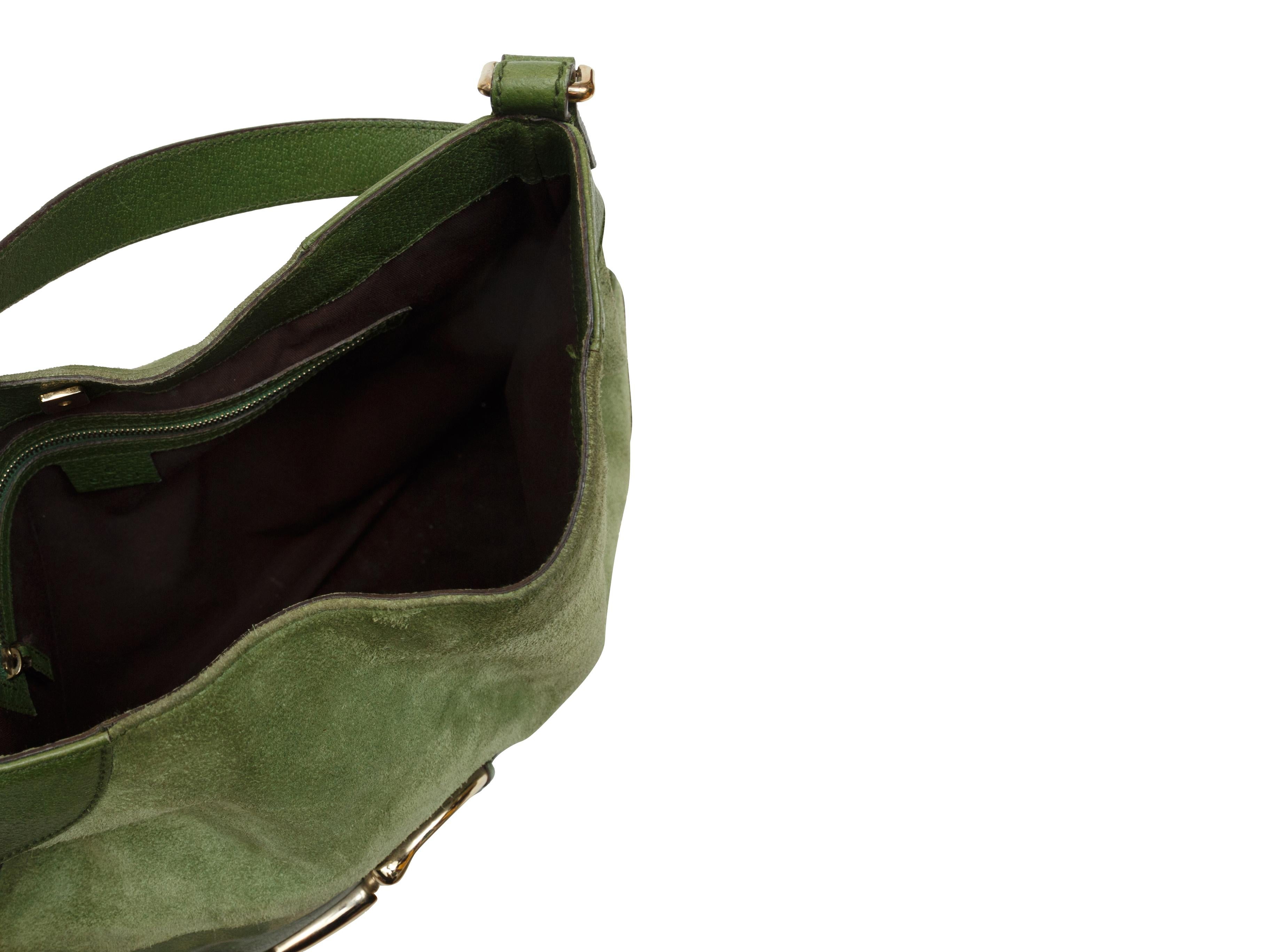 Product details: Green suede Hassler Hobo shoulder bag by Gucci. Tonal leather trim throughout. Gold-tone horsebit accent at front. 16