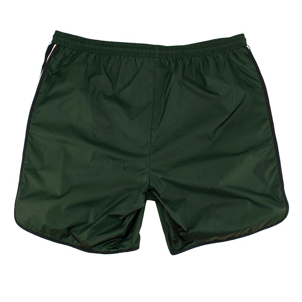 Gucci Green Swim Shorts with Logo Stripes

-Classic cut
-Branded knit interlocking 'GG' logo stripes to the sides 
-lightweight, quick-drying fabric
-Interior lining for extra comfort 
-Elasticated waist for practicality 

Materials:
100%