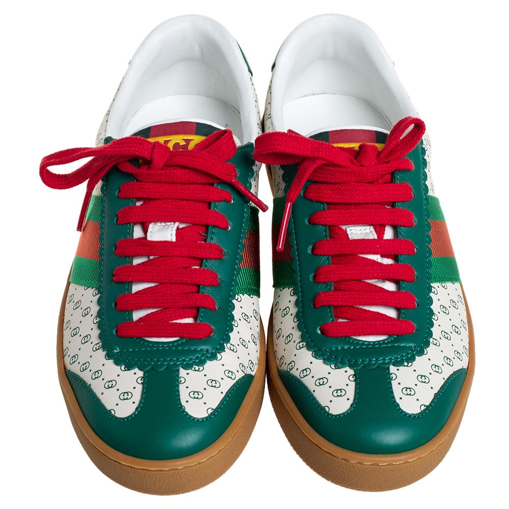 This pair of Gucci sneakers will make a mark for themselves in your closet. Crafted in Italy, they are made of quality leather and come in lovely hues of white and green. These Dan sneakers feature the brand's signature Web detailing, contrast