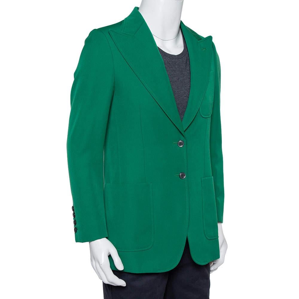 A splendid style statement is assured when you step out wearing this amazing Gucci blazer. The green creation is made of wool and exhibits peak lapels, a chest pocket, two slip pockets, dual front button fastenings, and long sleeves. It will look