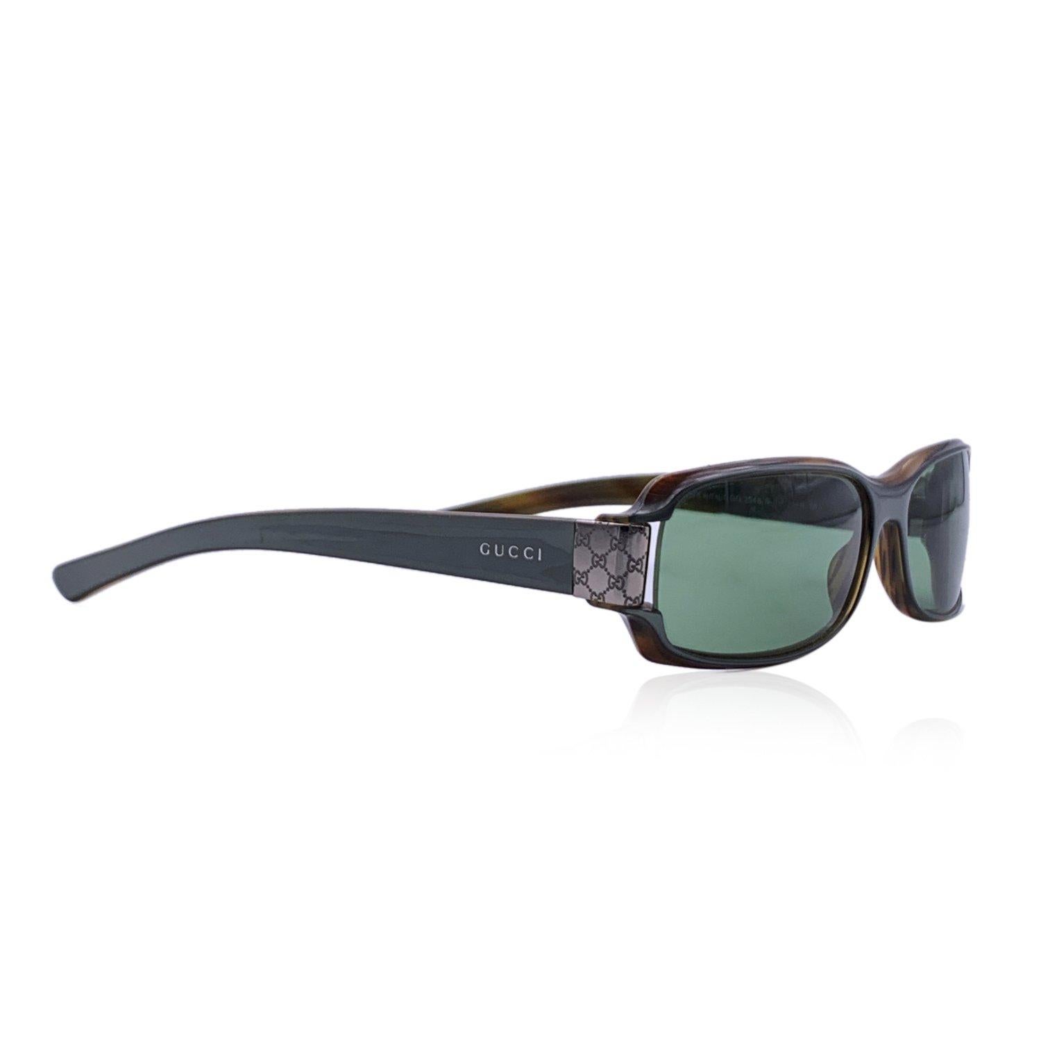 Gucci Sunglasses- Model: GG2548/S. Rectangular shape. Grey acetate frame. Green lenses. Silver metal details on temples with monogram pattern. Made in Italy. Details MATERIAL: Acetate COLOR: Grey MODEL: GG 2548/S GENDER: Women COUNTRY OF