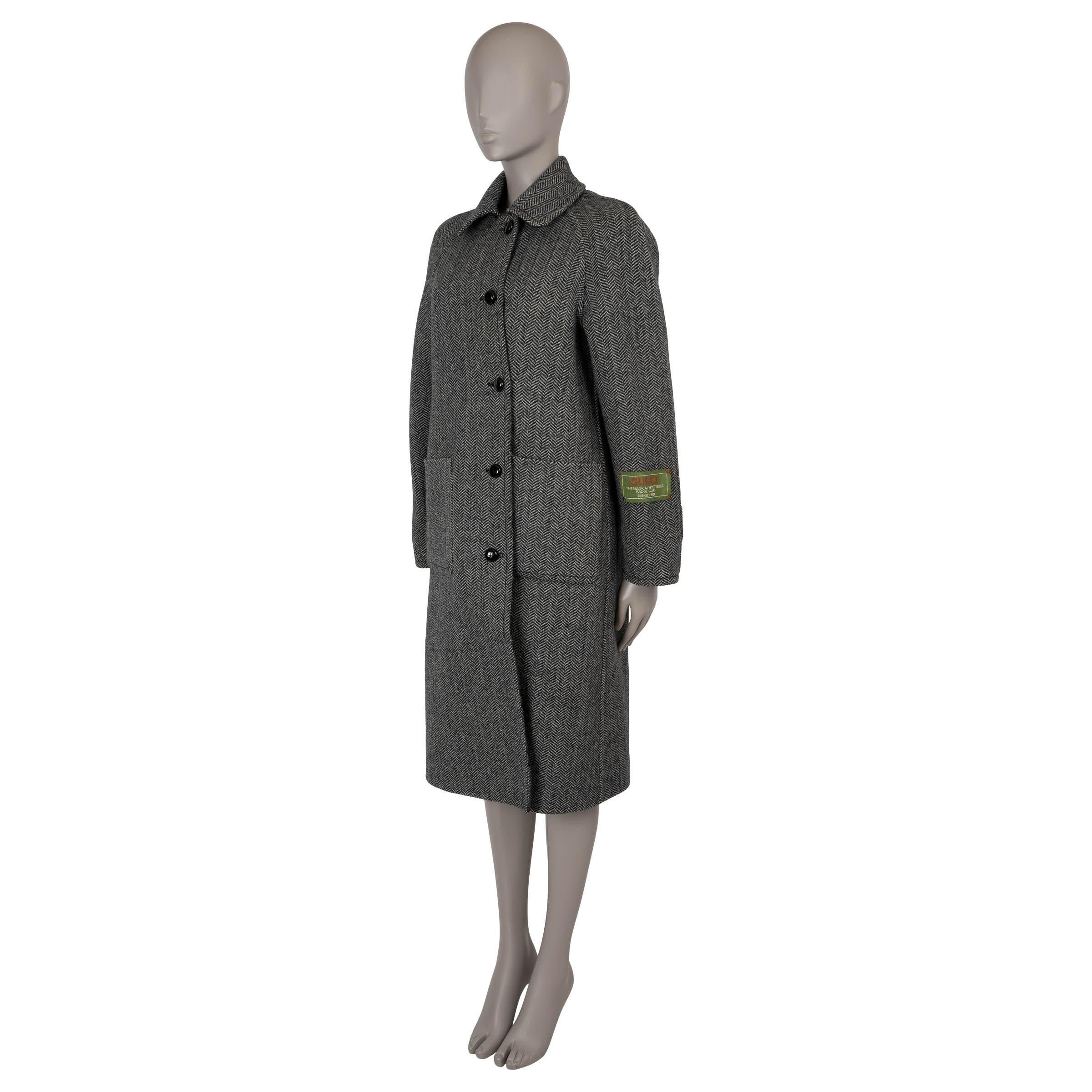 This 100% authentic Gucci reversible coat in grey and black wool offers two distinctive looks in one stylish piece. One side features a classic chevron pattern, while the other showcases the iconic GG Monogram. Designed with a point collar, raglan