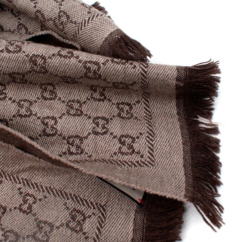 Gucci Grey-Brown GG Monogram Wool Scarf
 
 
 
 - GG Monogram jacquard scarf 
 
 - Crafted from wool in beige and brown hues
 
 - Frayed edges
 
 
 
 Materials:
 
 The item does not have a care label but we believe it is wool
 
 
 
 PLEASE NOTE,