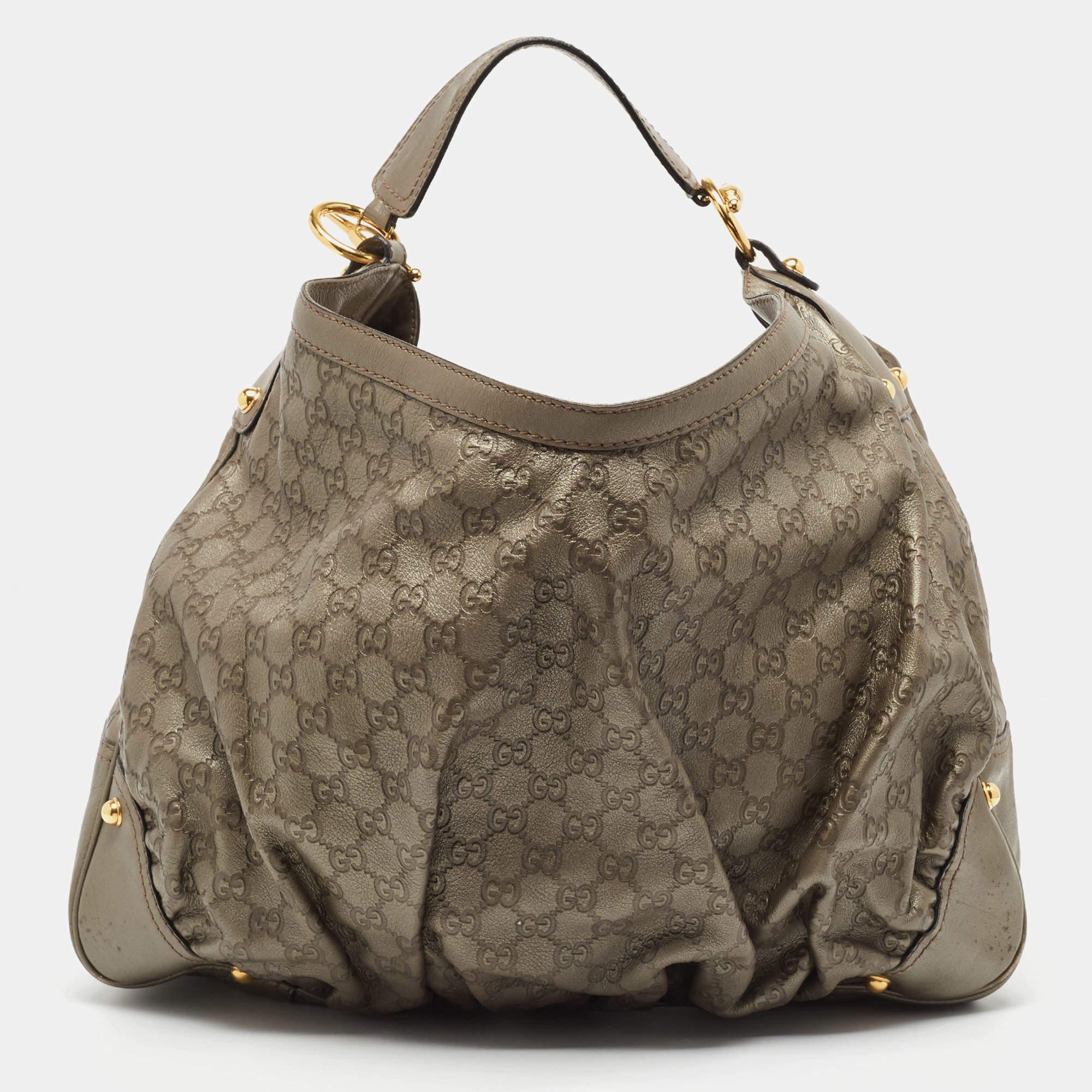 Crafted in the Guccissima leather, this spectacular tote bowls us over with finesse. Its striking gold-tone hardware, comfortable strap and studded corners accentuate the look. The zip-enclosed interior lined with fabric features one zipped pocket.