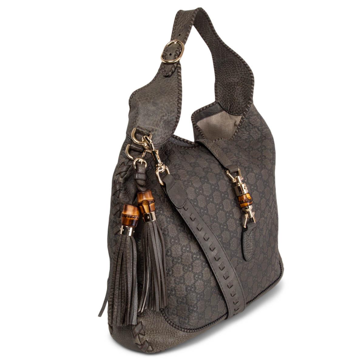 100% authentic Gucci New Jackie Large hobo shoulder bag in petrol-grey grained and Guccissima embossed calfskin featuring light gold-tone hardware and bamboo detail lock. Lined in off-white canvas with one zipper pocket against the back and two