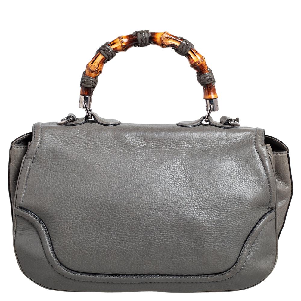 Bags from Gucci are on every woman's wishlist. So, own this gorgeous bag today and light up your closet! Crafted from leather, this fabulous grey number has a front flap that is detailed with the signature bamboo motif as the turn-lock and opens to