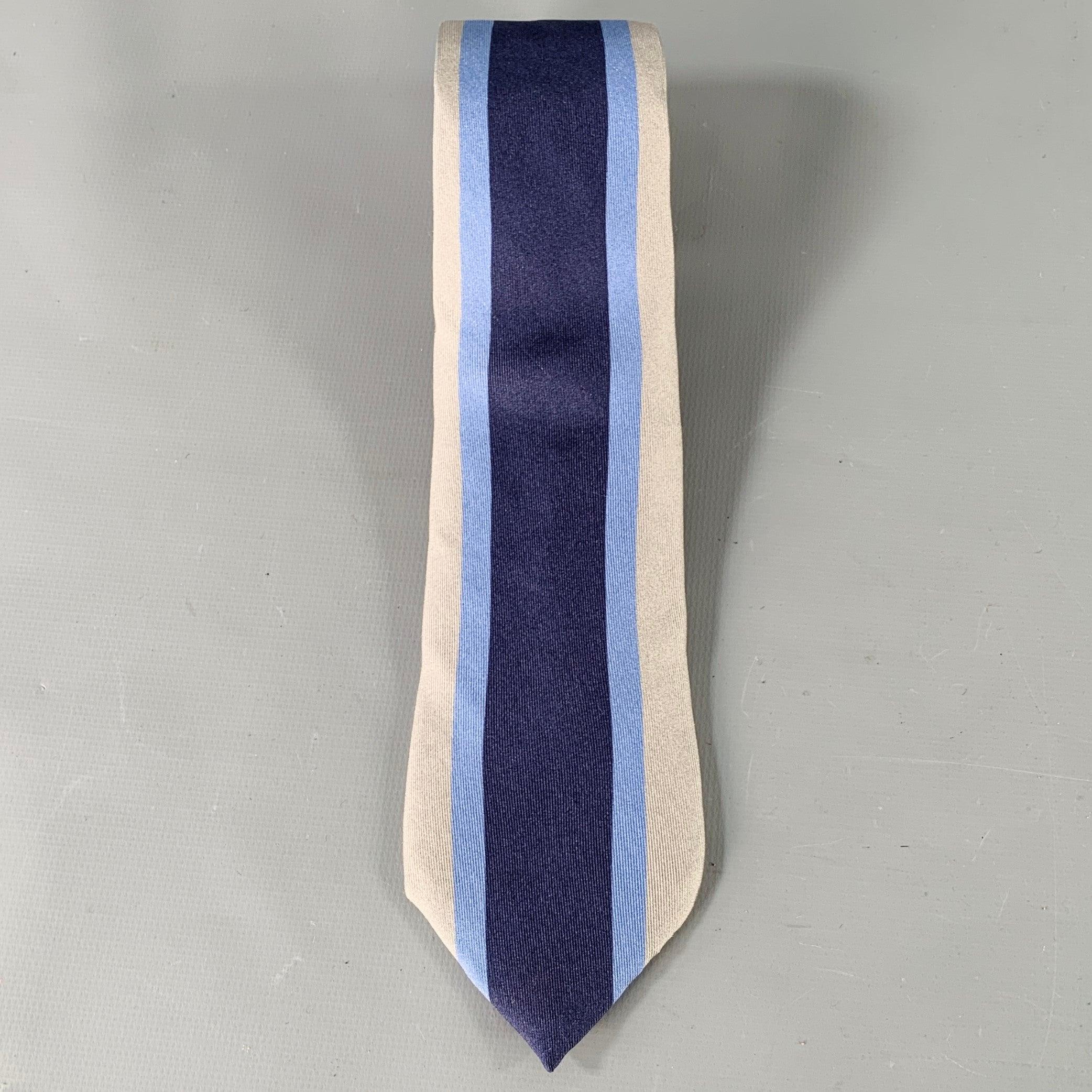 GUCCI necktie
in a grey, navy, and blue silk featuring a vertical stripe and skinny style.Excellent Pre-Owned Condition. 

Measurements: 
  Width: 2.5 inches Length: 60 inches 
  
  
 
Sui Generis Reference: 137282
Category: Tie
More Details
   