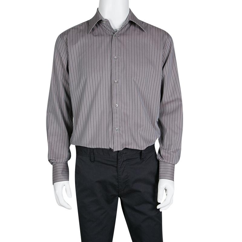 Exhibiting the minimalistic charm of Gucci, this classic grey shirt with perfect fitting must be added to your formal closet. It is fabricated in cotton with a striped pattern all over. It has a button front closure and long sleeves for maximum