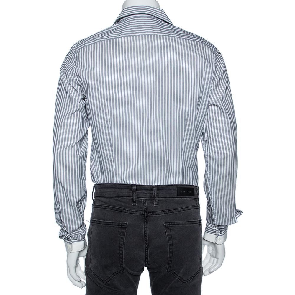 Shirts are an indispensable part of a man's wardrobe, so Gucci brings you a creation that is both versatile and stylish. It has been tailored from cotton in a grey shade. The shirt is detailed with striped patterns, front buttons, a classic collar,