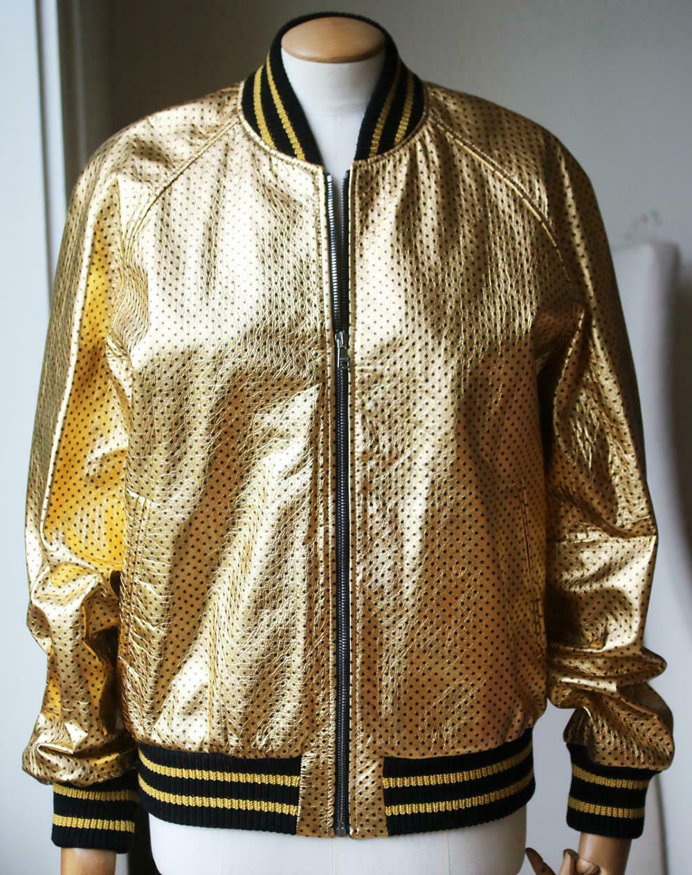 Gold leather with black stars and Guccy in SEGA font. Knit trim. Front pockets.
Zip closure. Cotton lining. Made in Italy. Colour: gold. 100% Lambskin leather.

Size: IT 44 (UK 12, US 8, FR 40)

Condition: As new condition, no sign of wear. 