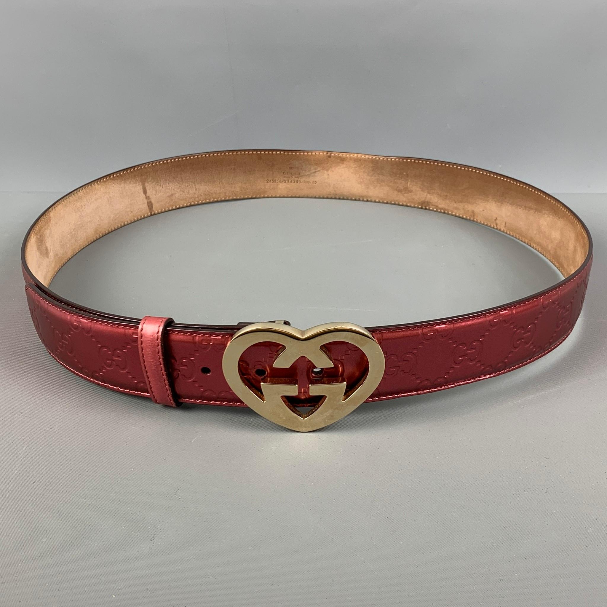 GUCCI 'Guccisima Interlocking' belt comes in a pink embossed GG details featuring a gold tone heart shape buckle. Made in Italy.

Good Pre-Owned Conditions. As- Is.
Marked: 245856 214351 100 40

Length: 44 in.
Width: 1.5 in.
Fits: 35 in. - 40