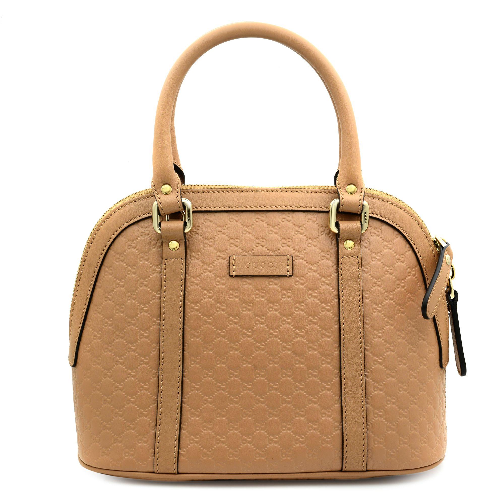 Gucci Beige Leather Mini Convertible Micro GG Guccissima Dome Satchel Shoulder Bag 449654. This chic tote is crafted of embossed microguccissima leather in beige. The bag features leather handles, an optional shoulder strap, and light gold hardware.