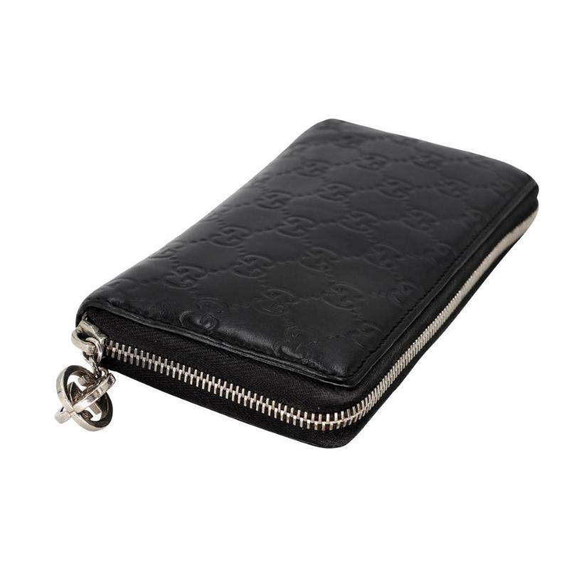 Gucci Guccissima Large GM Zippy GG Wallet GG-1203P-0002

This Gucci Black GG Coated Canvas Large Flap Wallet is a chic way to organize your essentials like your bills and cards with ease. It features GG coated canvas with patent leather trim and