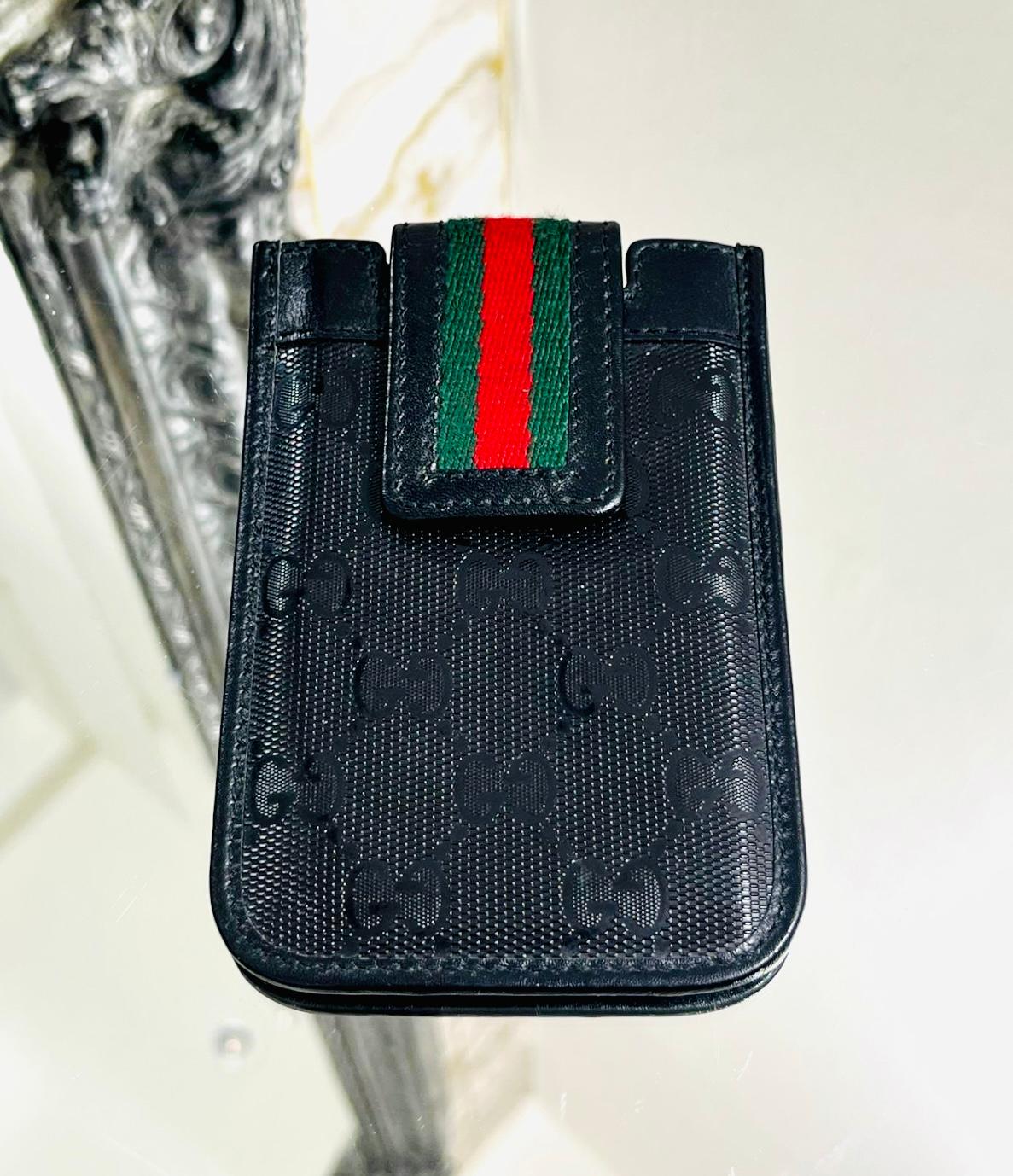Gucci Guccissima Leather iPhone Case

Black case designed with iconic 'GG' logo monogram.

Detailed with the brand's signature green & red striped snap button closure.

Size – Height 13cm, Width 8cm, Depth 1cm

Condition – Very Good

Composition –