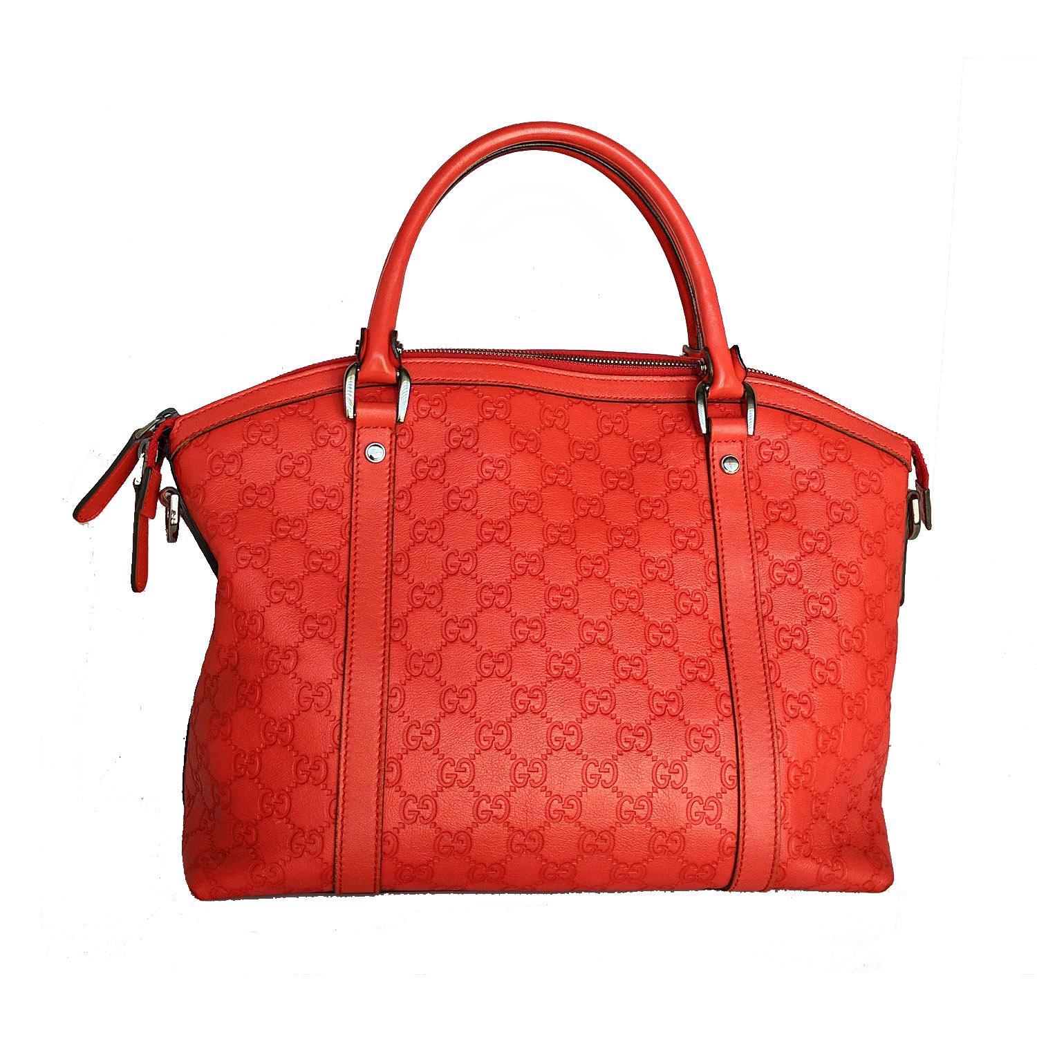 This stylish tote is finely crafted of Guccissima monogram embossed leather in red. The tote features thin and sturdy leather strap top handles and a top zipper. The bag opens to a fabric interior with a zipper and patch pockets.

Designer:
