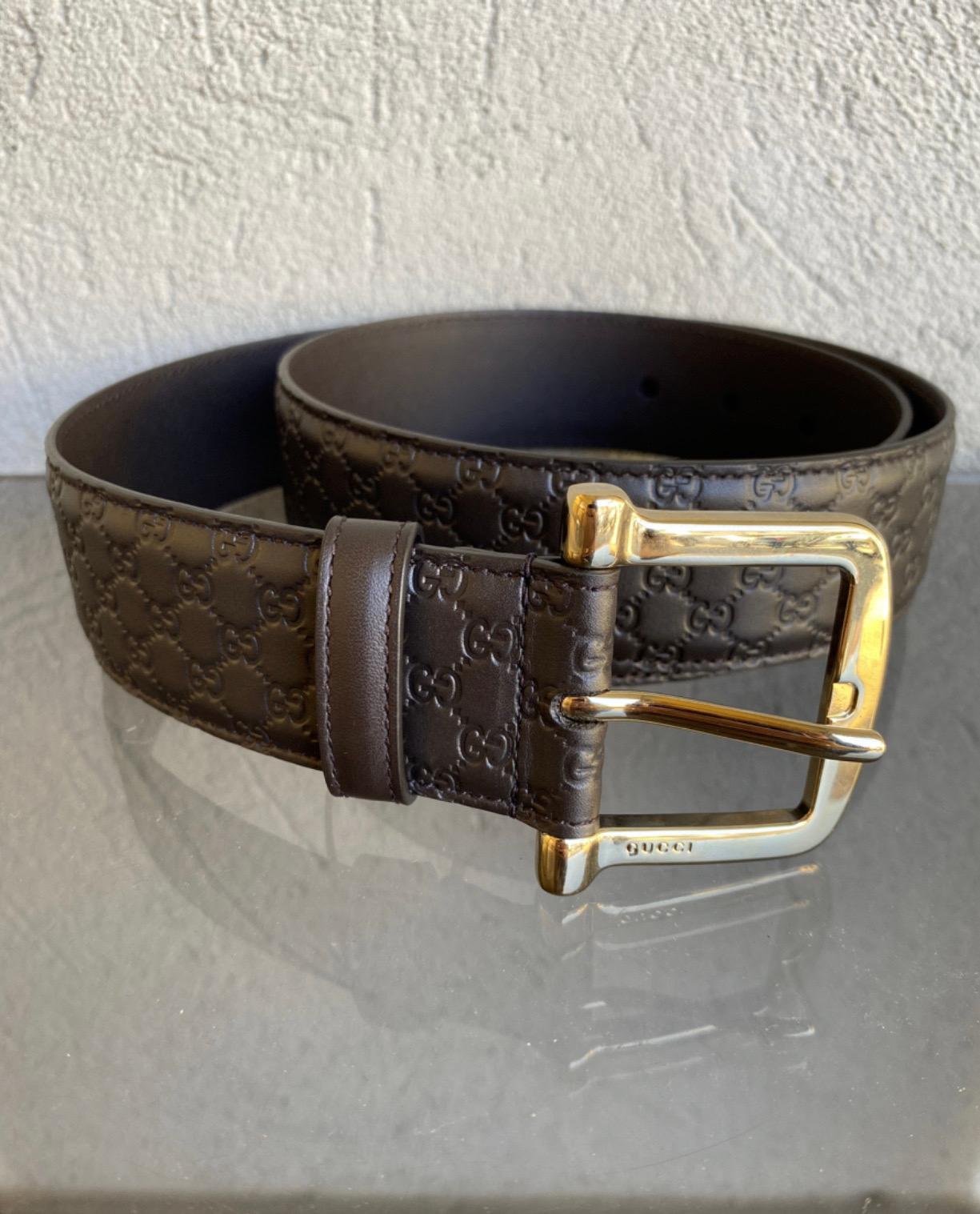 Gucci belt monogram Guccissima, dark brown leather, with gold-colored steel parts, measures 85cm, has a height of 4cm, new, never used with dustbag.