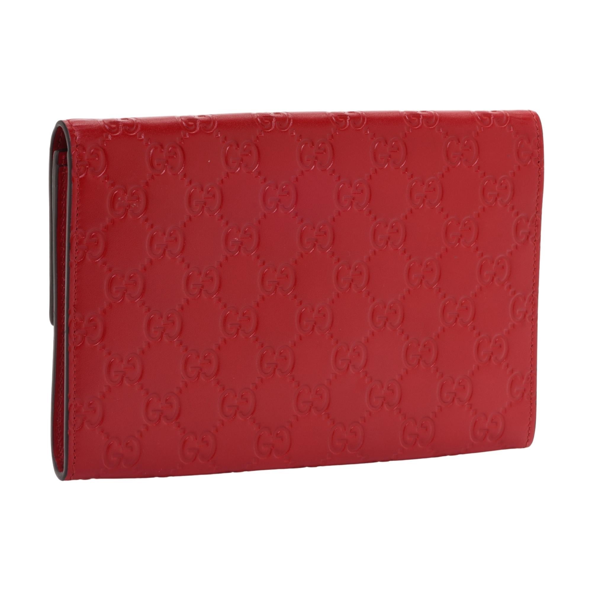 This clutch is made of Guccissima GG monogram embossed leather in red. The front padlock flap opens to a matching interior with card slots and a zip pocket.

COLOR: Red
MATERIAL: Leather
ITEM CODE: 453156
MEASURES: H 5.25” x L 8.25” x D 1”
COMES
