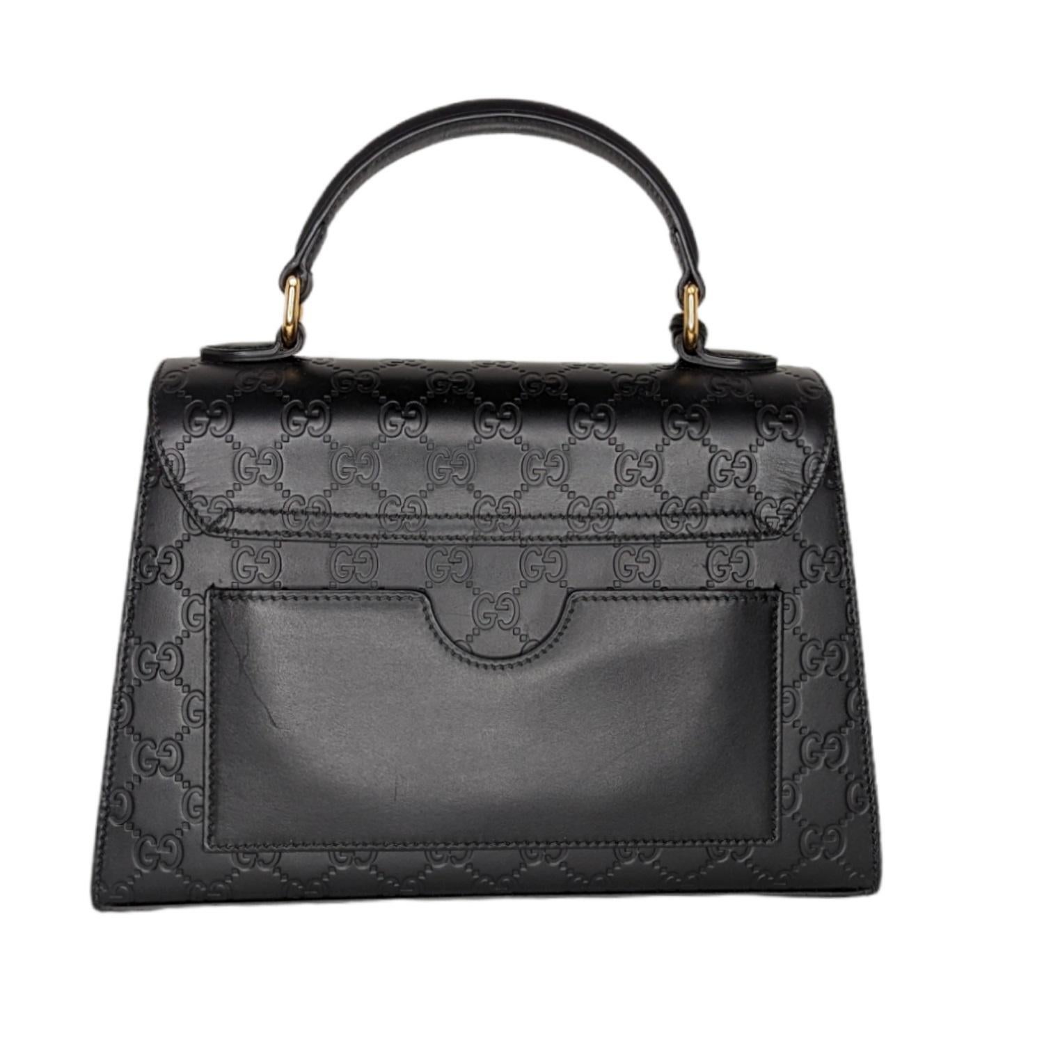 This stunning Gucci was created in a new shape for the Padlock collection and is a perfect size! The bag features gorgeous signature embossed GG leather with stunning gold-tone hardware, a top handle and detachable shoulder strap. The interior is