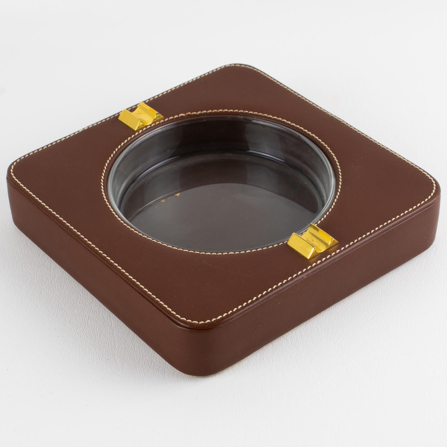 Designed by Gucci Italy and expertly crafted circa 1970, this exceptional modernist desk accessory exemplifies the brand's dedication to luxury and design. The generously scaled ashtray features a bold square form, meticulously wrapped in