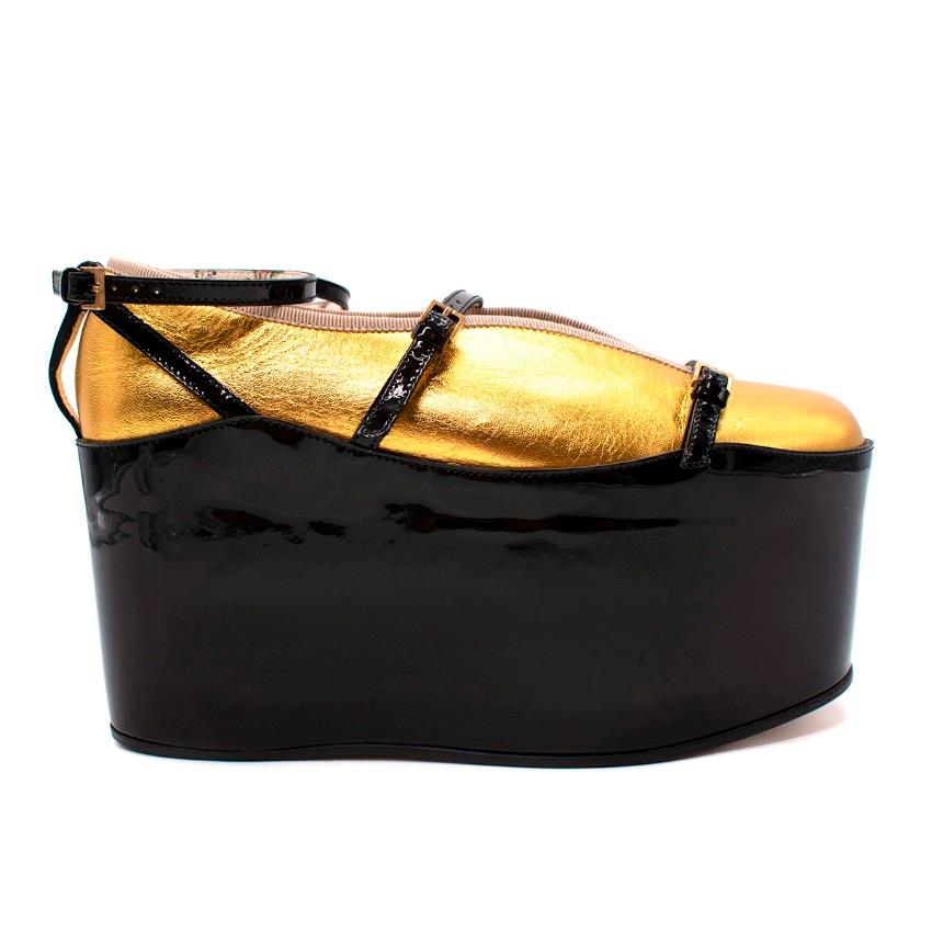 
Gucci Hannelore Gold Leather Ballerinas With Black Ankle Strap Platforms

- Detachable black patent platform with adjustable buckle straps
- Metallic gold ballet flats feature elasticated ribbed trimming
- Front slit vamp

Materials:
Leather

Made