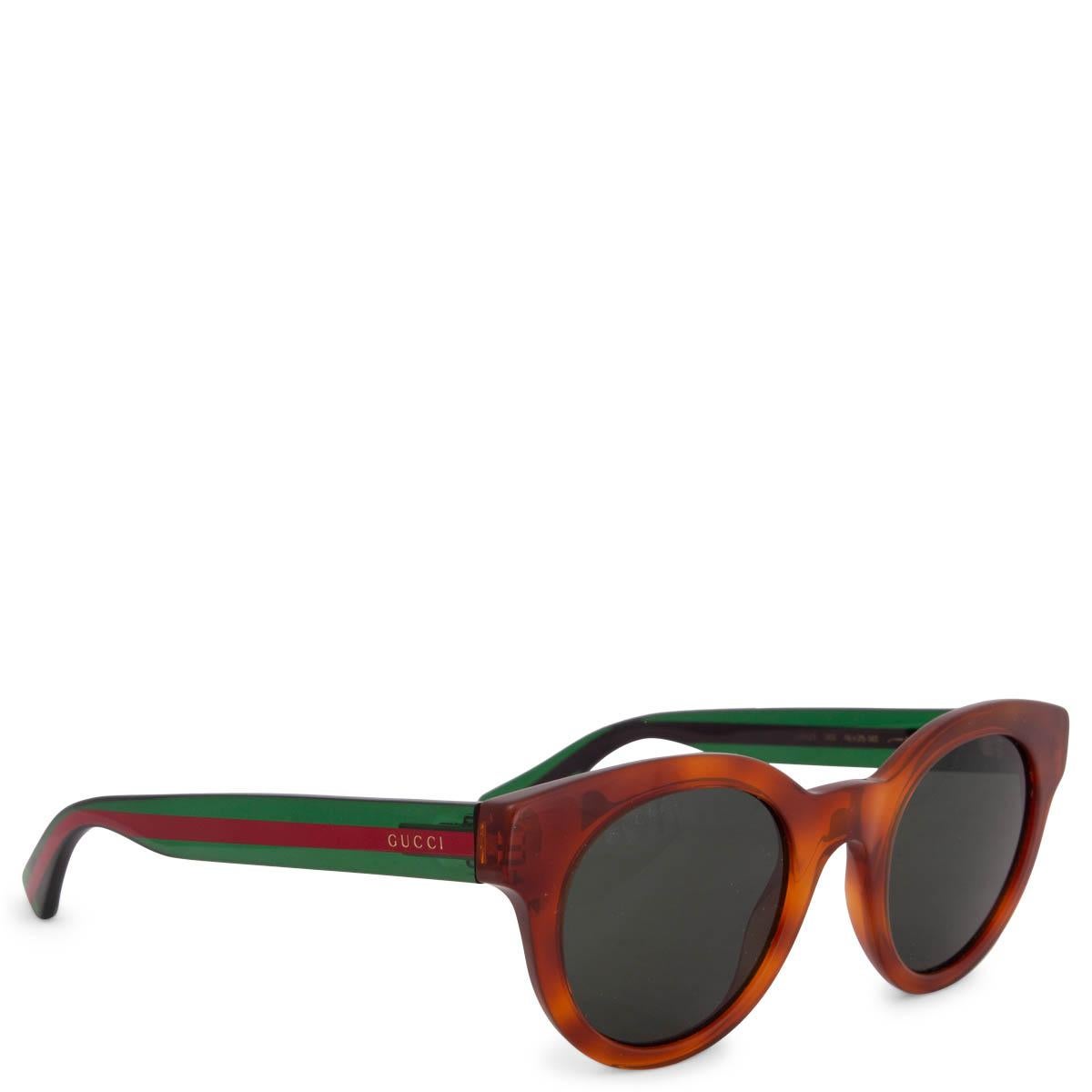 100% authentic Gucci GG0002S Round Tortoiseshell Havana Sunglasses in cognac brown acetate with red and green striped temples and green lenses. Have been worn and are in excellent condition. Come with case. 

Measurements
Model	GG0002S
Width	13.5cm