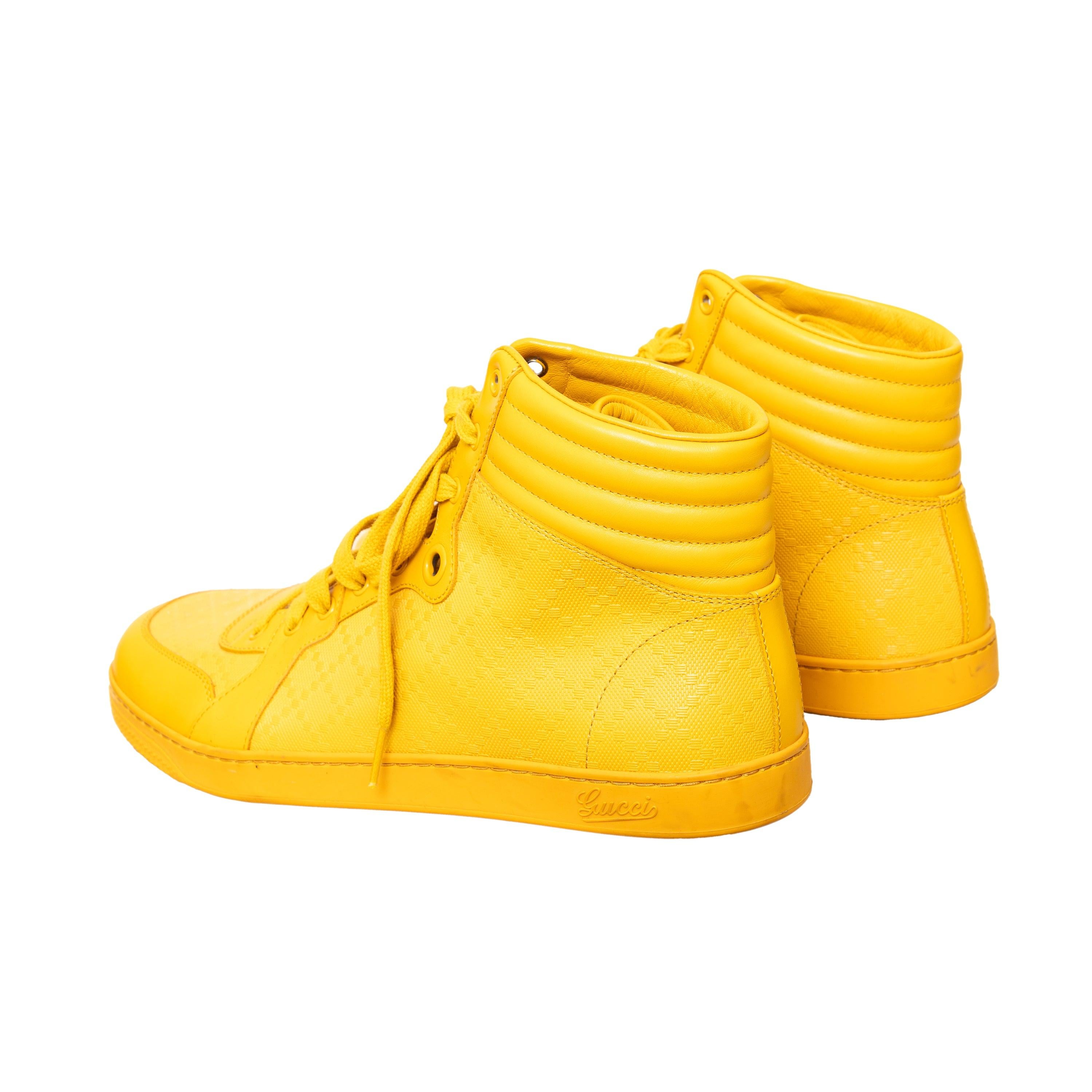 These Gucci high top sneakers are striking, trendy, and comfortable. Crafted from Diamante leather, they feature a bright yellow color, high-top silhouette, lace-ups, and logo detailing. Perfect for making a bold fashion statement and providing