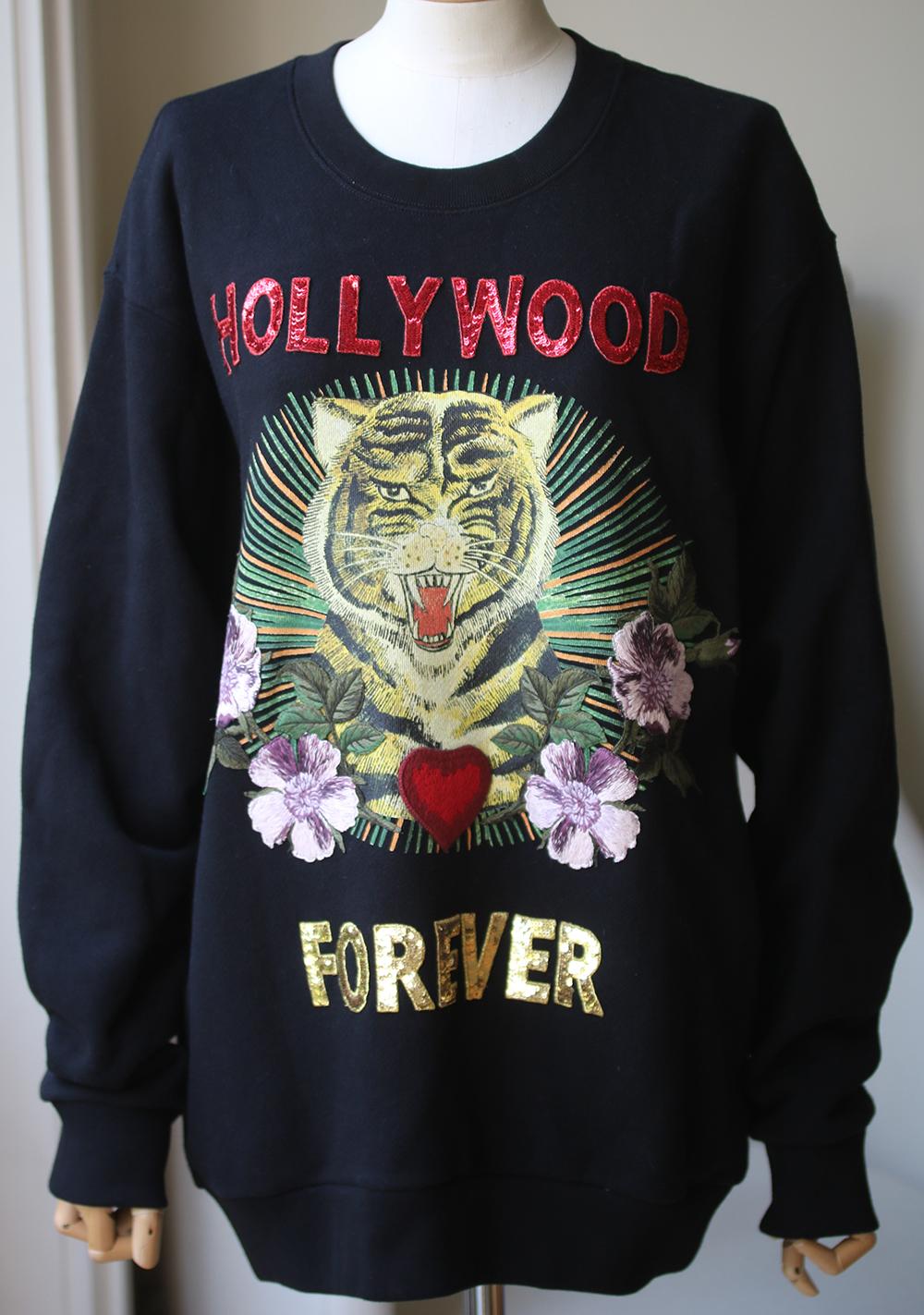 Add an edge to your casual wear with this embroidered sweatshirt from Gucci. Crafted in Italy from soft black cotton, this sweatshirt features beautiful, unique embroidered and print details to the front and back; a printed Tiger to the chest with