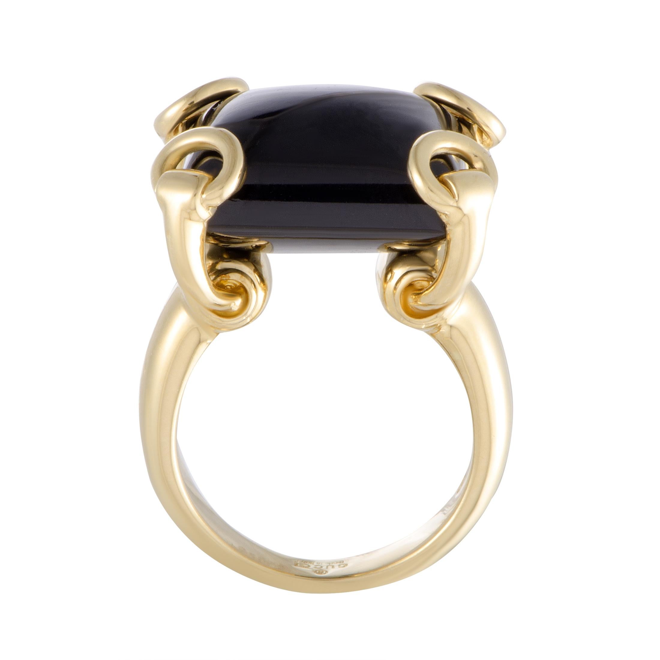 Gucci makes a bold statement with this 18K  yellow gold and onyx cocktail ring - the smooth cabochon of onyx is held in place in each corner by the Gucci horsebit in gold.
Ring Top Dimensions: 15mm x 20mm