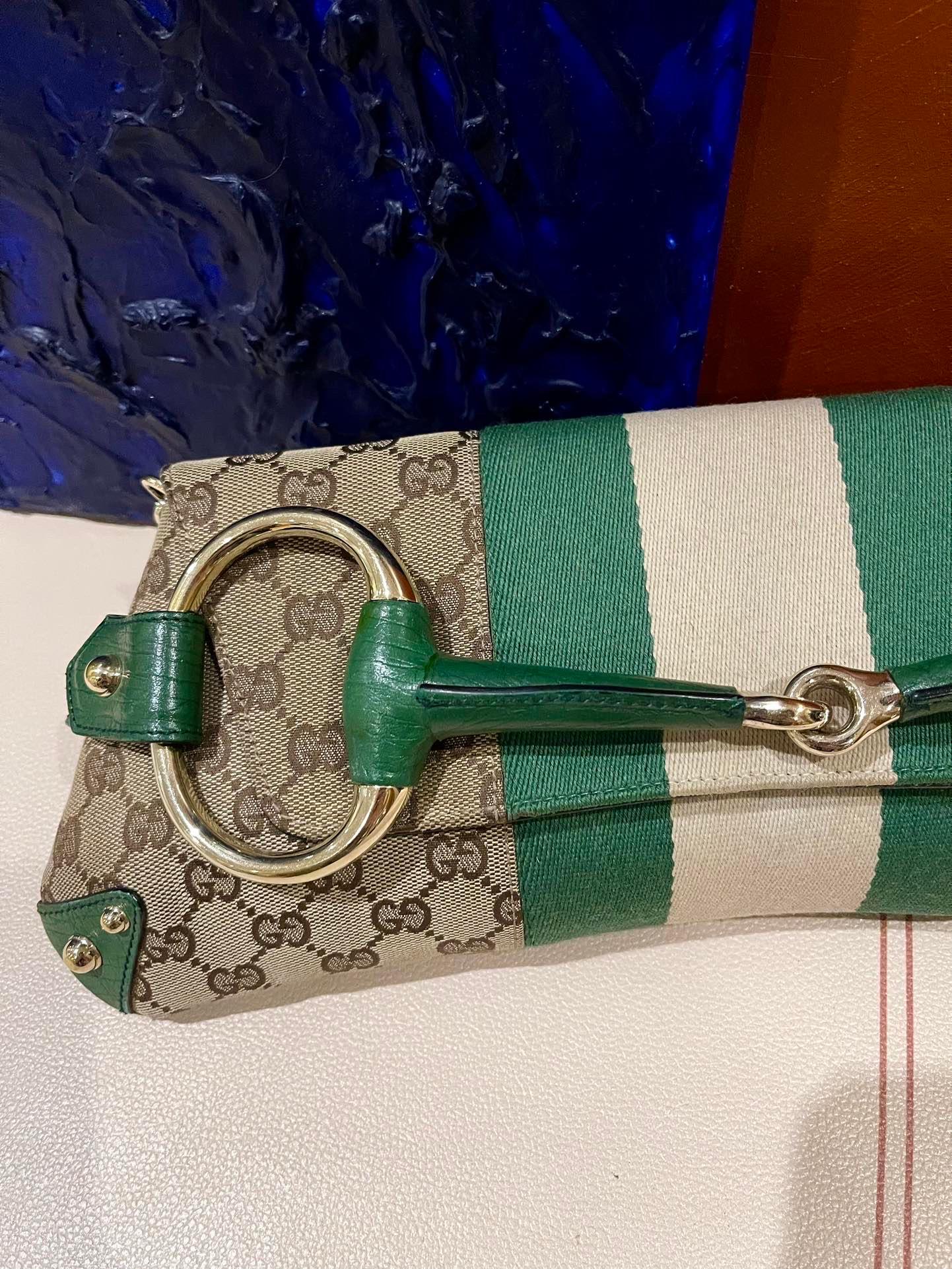 Make a statement with this large Gucci shoulderbag. Crafted from iconic Gucci monogram in beige cloth, with green Gucci signature strips, green leather lining and gold hardware and metal studs. This cool classic will make heads turn!


This model is
