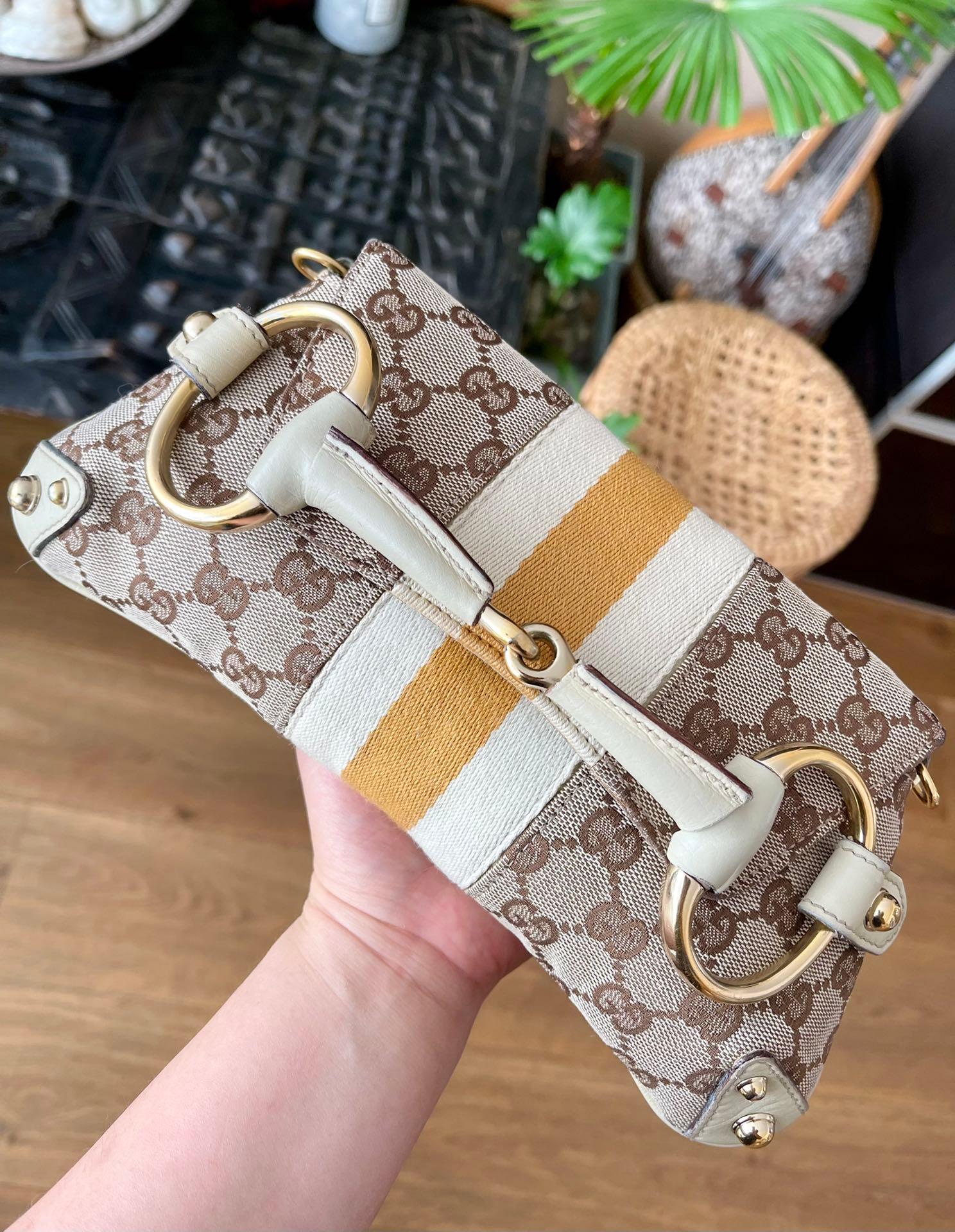 Make a statement with this large Gucci shoulderbag. Crafted from iconic Gucci monogram in beige cloth, with burgundy leather and gold tone hardware. This cool classic will make heads turn!

This model is revived in the Gucci 2023 Fall/Winter