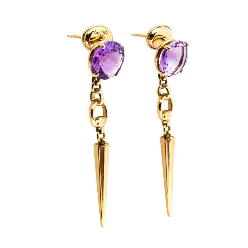Perfectly designed for a statement look, these drop earrings from Gucci flaunt the iconic Horsebit motif in a refreshing style. The pair features amethyst stone studs with 18k yellow gold horsebit-like spike drops. These beauties are not only