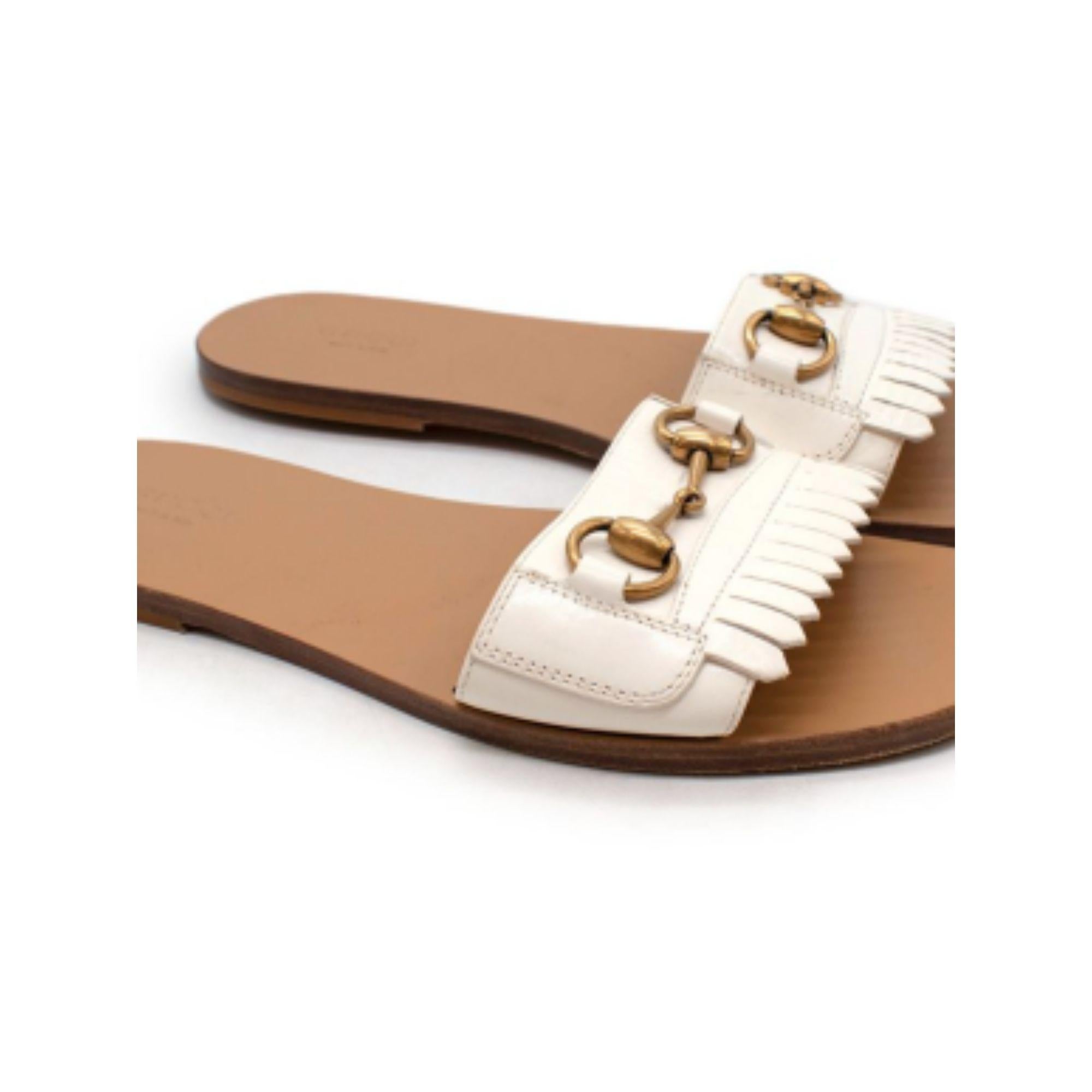 Gucci Horsebit-detailed fringed leather slides

- Branded and leathered soles
- White firing leather details
- Gold buckle
- Slide-on

Material
Leather

Made in Italy

9.5/10 Excellent condition

PLEASE NOTE, THESE ITEMS ARE PRE-OWNED AND MAY SHOW