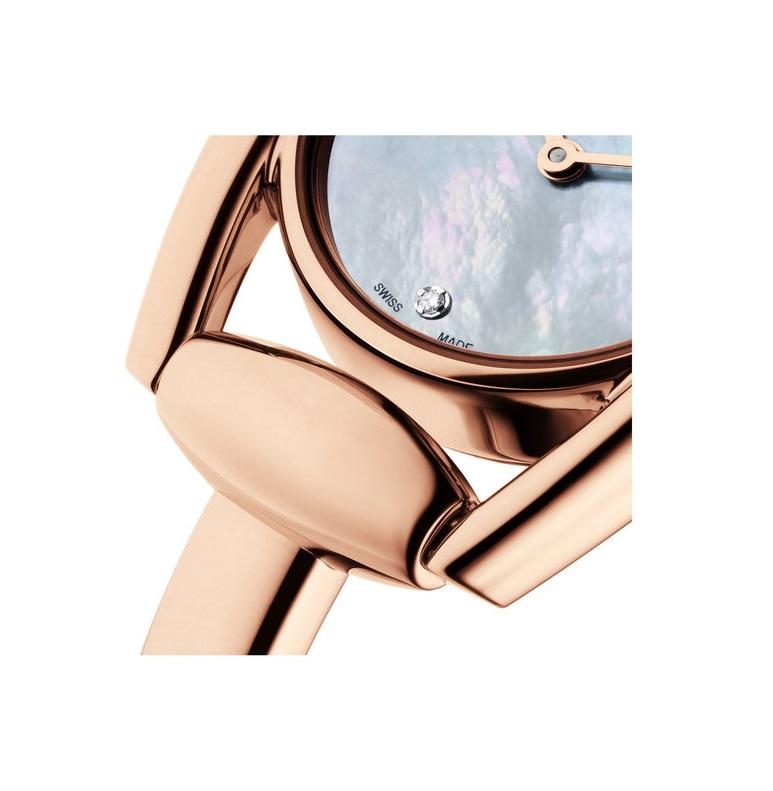 Rose gold PVD stainless steel case with a rose gold PVD stainless steel bangle bracelet. 
Fixed rose gold PVD bezel. 
Mother of pearl dial with rose gold-tone hands. 
Diamonds mark the 3, 6 and 9 o'clock positions. 
Dial Type: Analog. 
Quartz