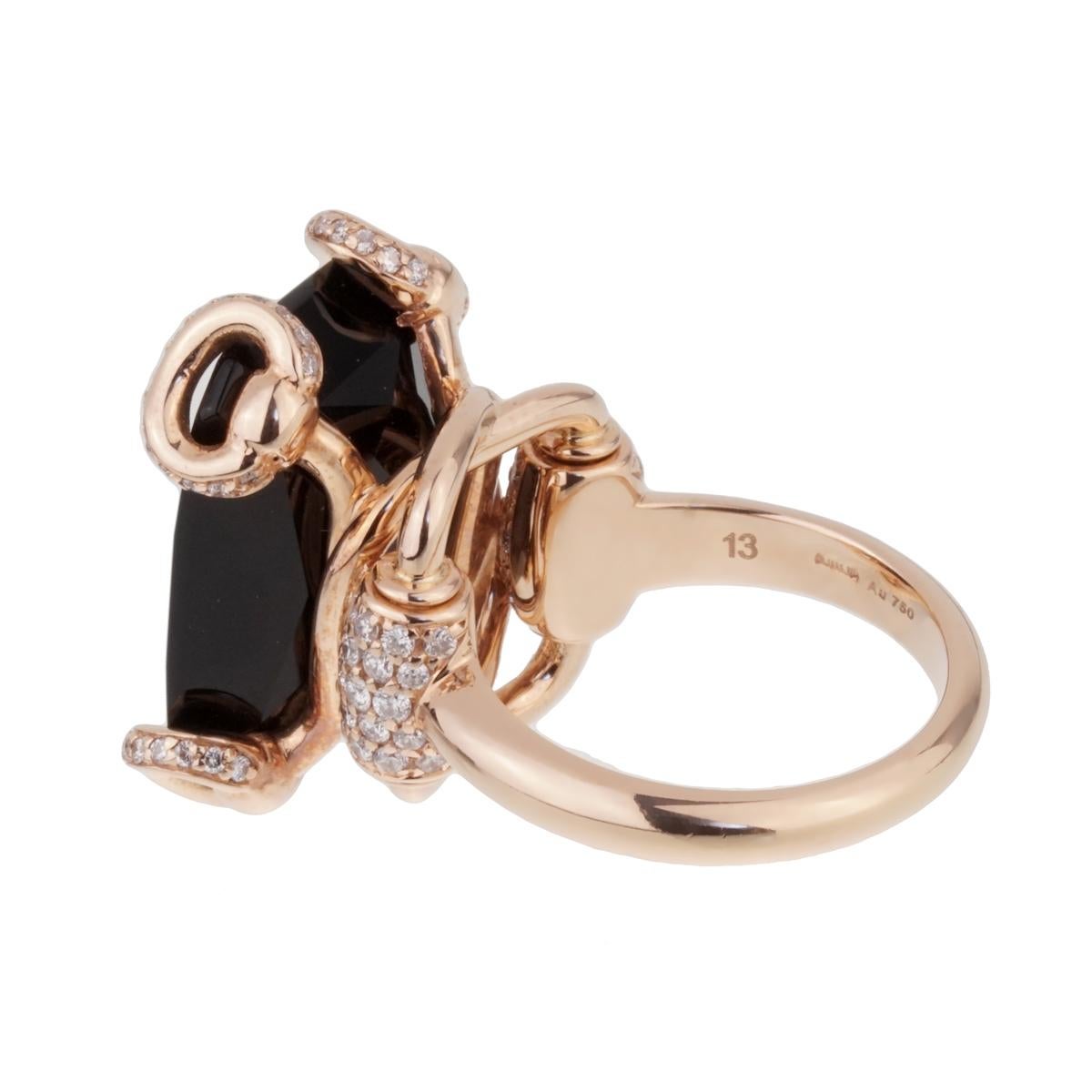 An iconic Gucci ring showcasing the glorious horsebit motif with a central faceted onyx adorned with round brilliant cut diamonds in 18k rose gold.