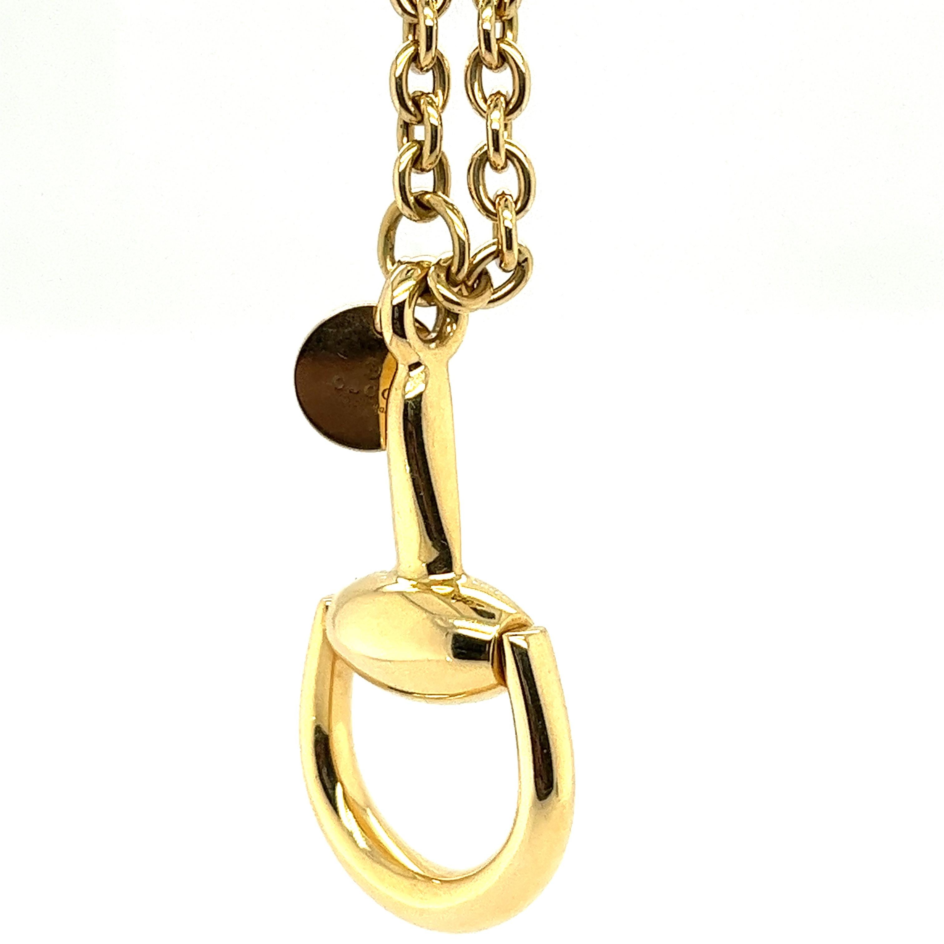 Gucci is known for its iconic horse bit collection, stemming from this collection is this stunning 18K yellow gold necklace with horse bit pendant. Small gold disc charm is attached with Gucci name stamped on it. 