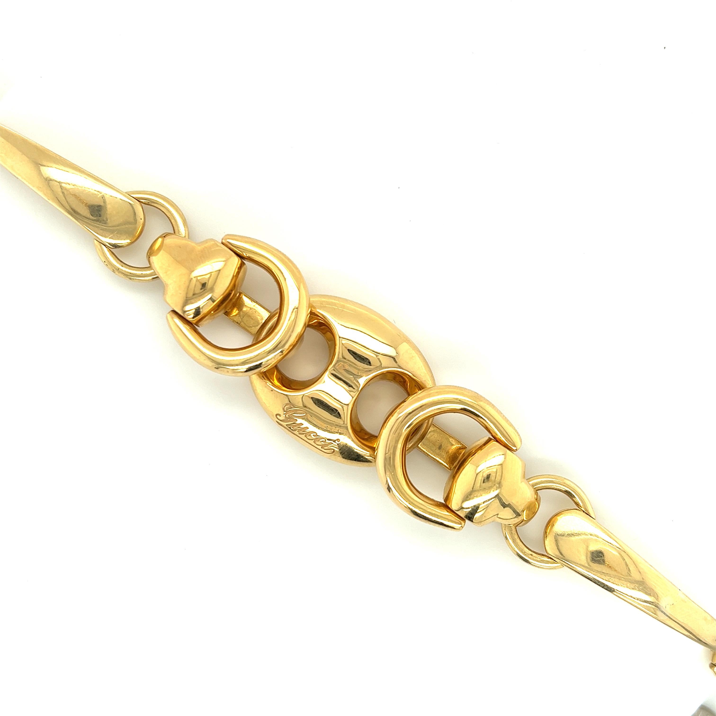 Beautiful bracelet crafted in 18k yellow gold by famed designer Gucci. 
The bracelet is known as the Horsebit Puff Link bracelet. 
The famous Gucci Puff link is centered by gold accents in a creative gold pattern. This light weight design is perfect