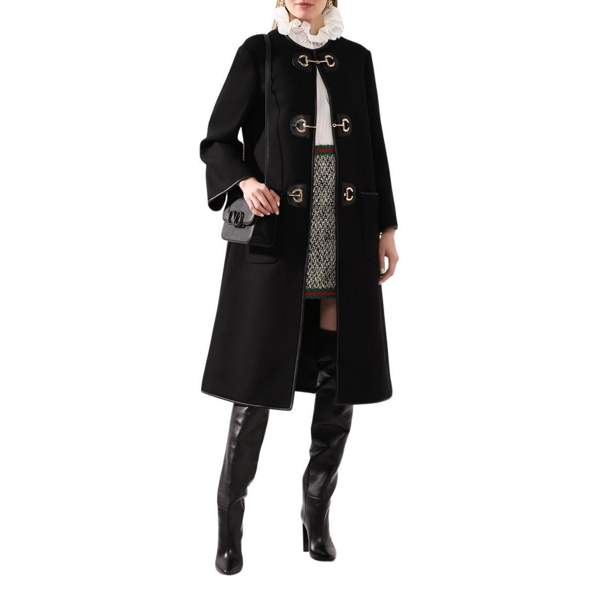 Gucci's Horsebit detail is presented in a gold-tone on the toggle fastenings through the front of this black wool-blend coat. Designed with a minimal single-breasted profile, the style is trimmed with leather for a refined finish. 
Round neck
Toggle