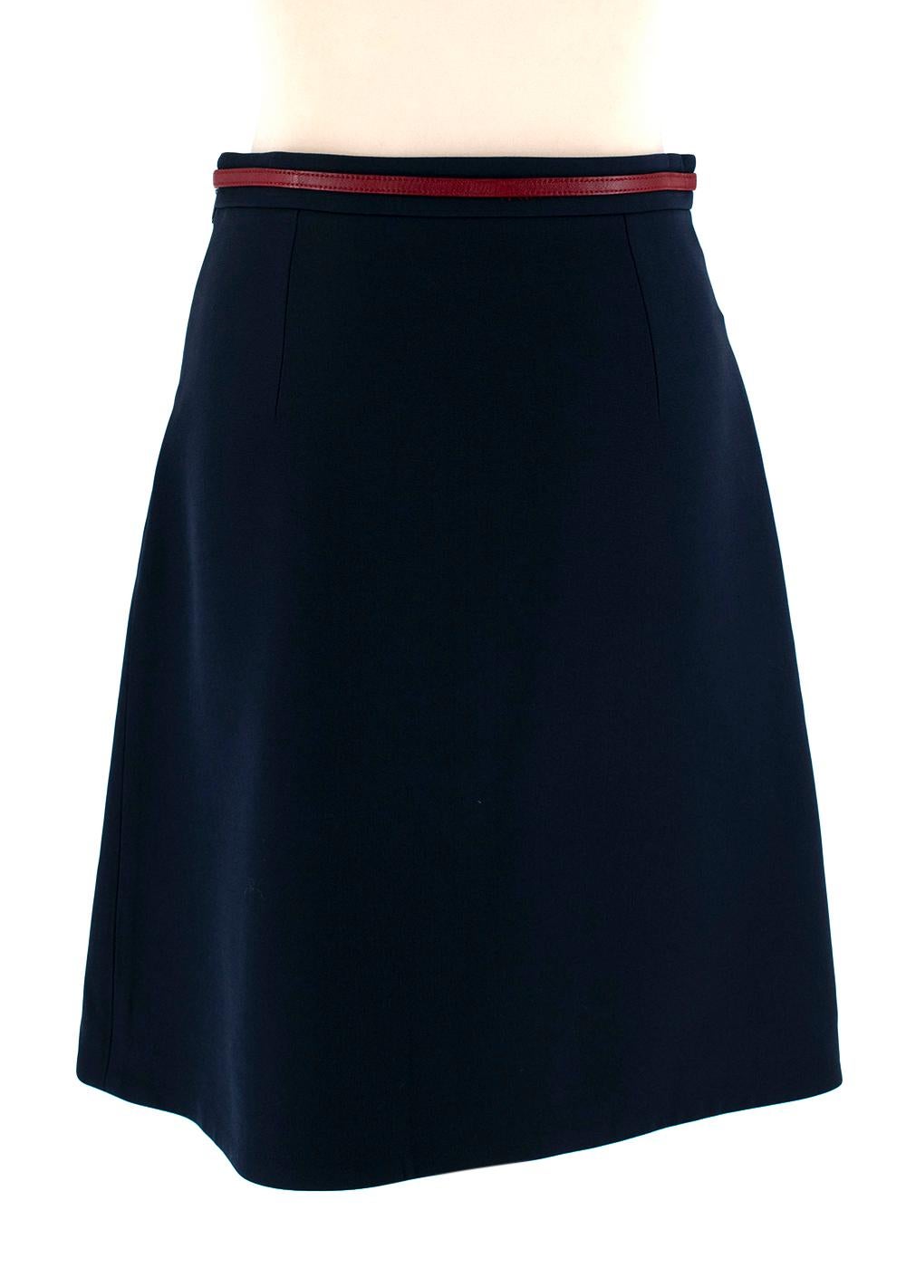 Gucci Navy Wool & Silk Blend Horsebit Skirt

- Classy below the knee length
- Red leather and gold hardware horse bit detailing around the waist
- Side zip fastening
- 'G' glass caramel & gold buttons with pleat in the middle
- Back darts to
