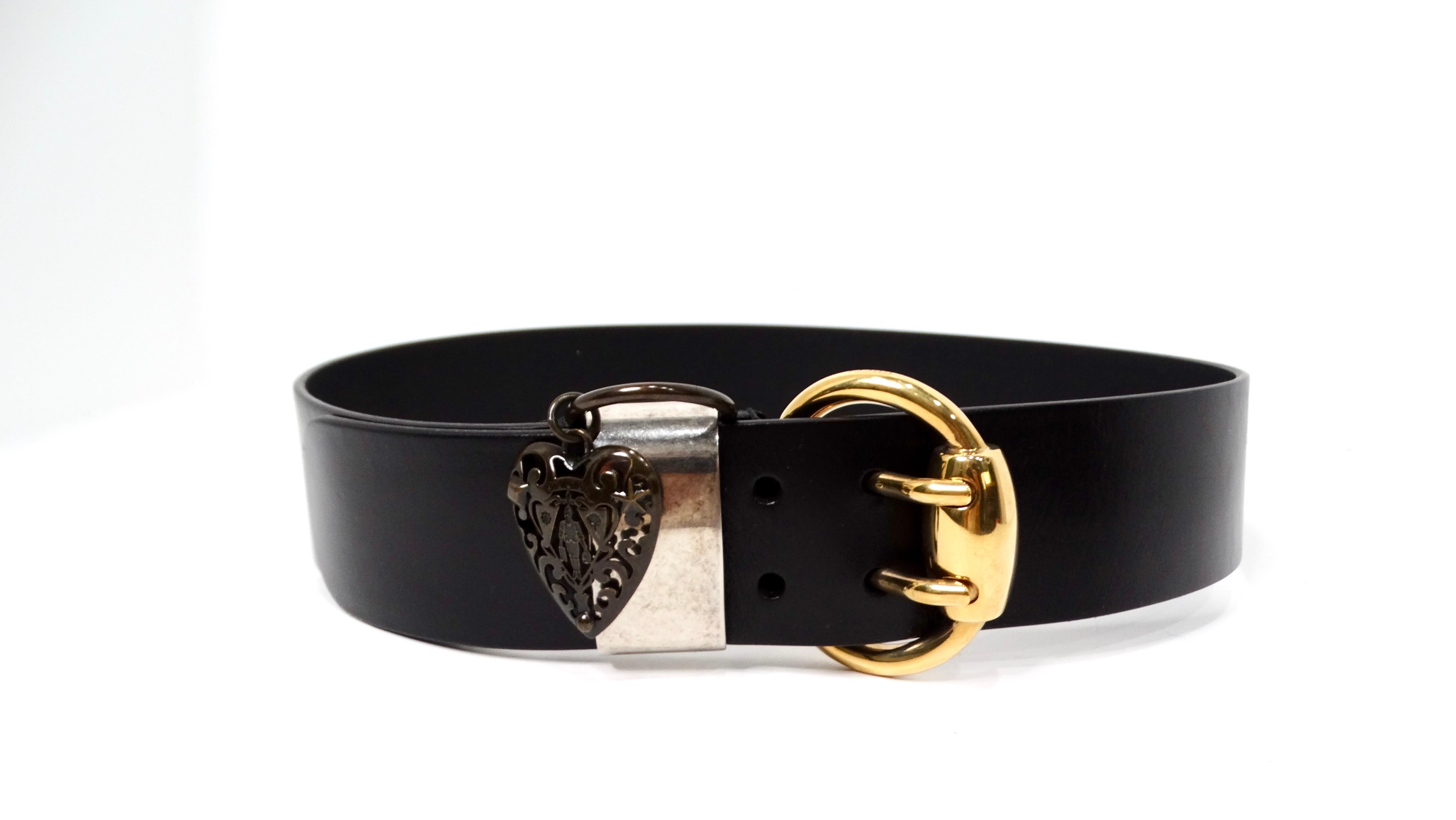 The Gucci Hysteria Heart Charm Black Calfskin Leather Belt is a striking addition to any high-fashion wardrobe. This wide belt, crafted from luxurious black calfskin leather, exudes sophistication and elegance. The standout feature is the gold-tone