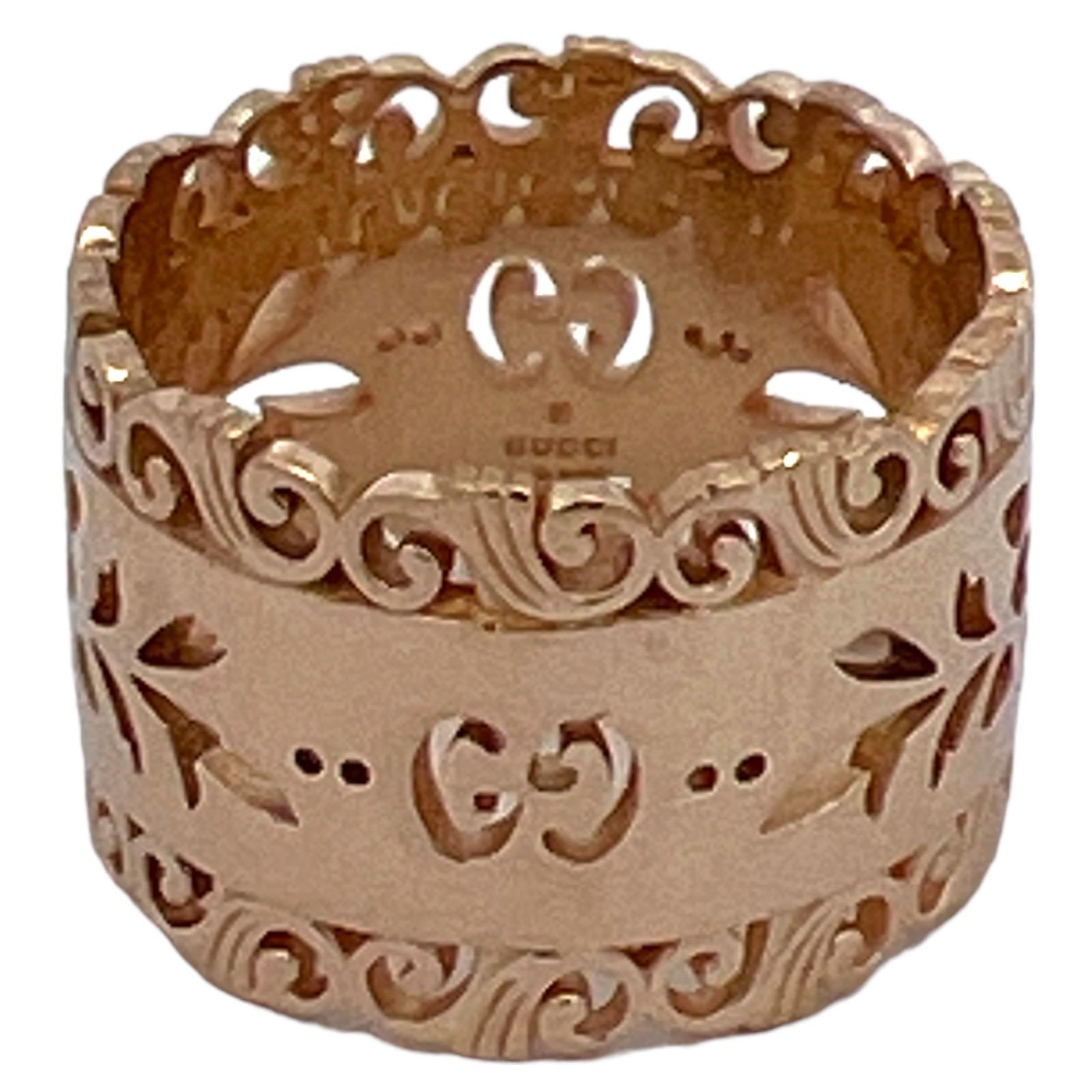 Gucci Icon Bloooms wide band ring fashioned in 18 karat yellow gold. The band features Gucci's signature GG logo and openwork design. The band measures 13.5mm in width, is size 7.5, and is signed Gucci Made In Italy  Icon Au 750 with Italian