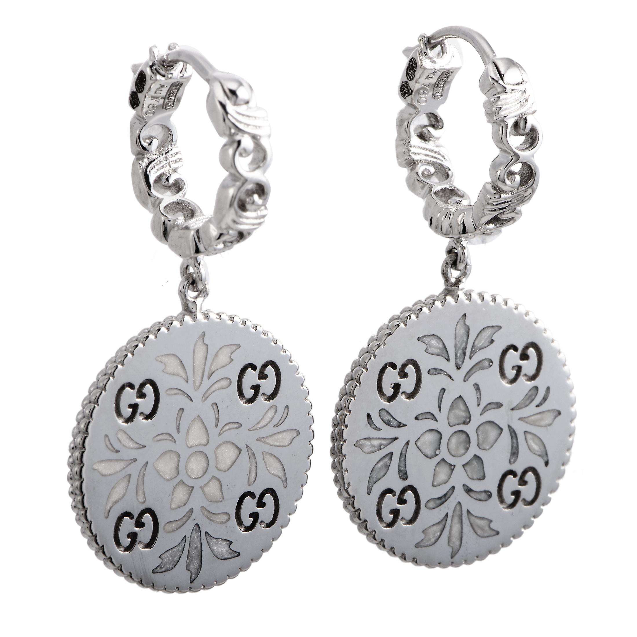 The Gucci “Icon Blooms” earrings are made out of 18K white gold and enamel and each of the two weighs 4 grams. The earrings measure 1” in length and 0.50” in width.