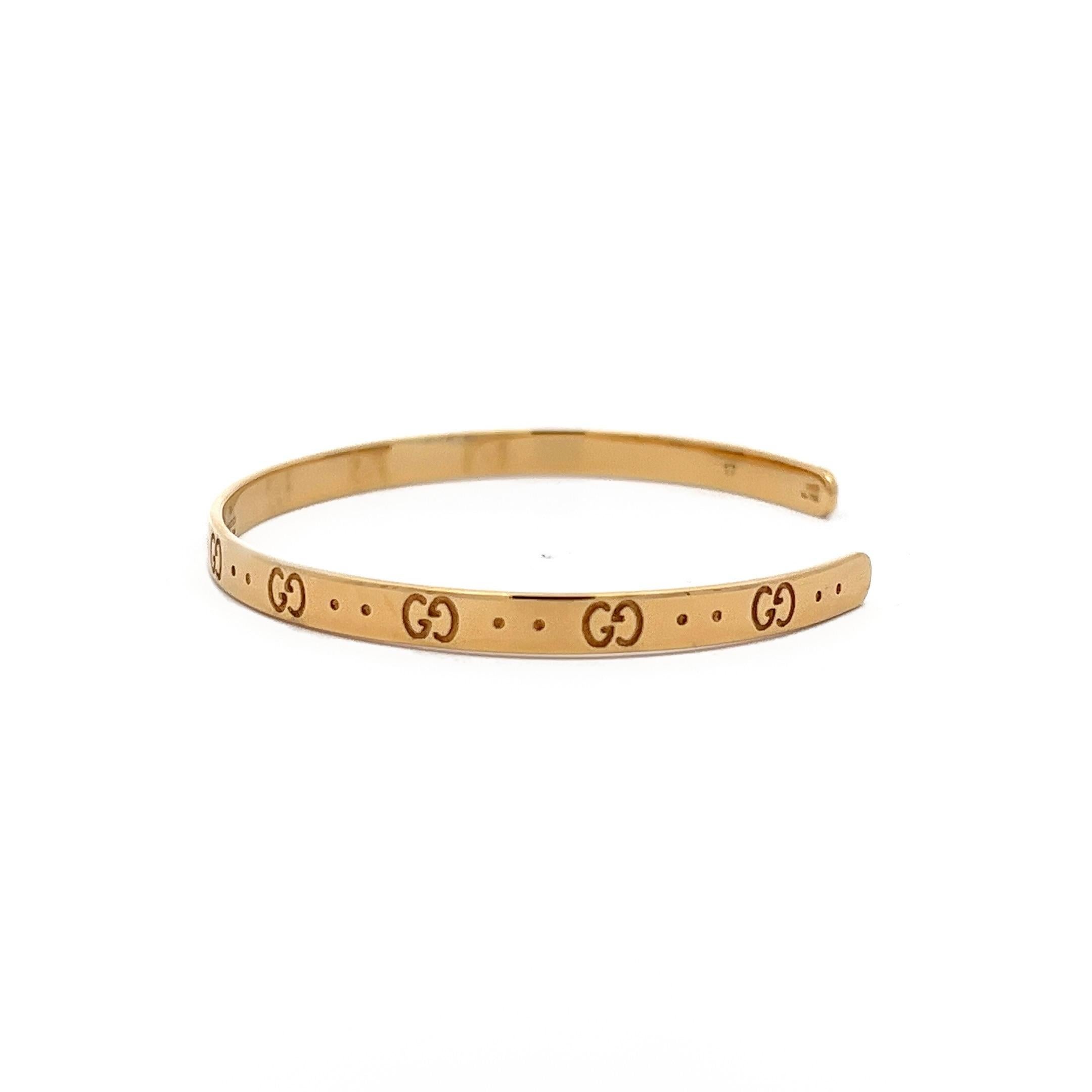 Introducing the Gucci Cuff Bracelet. Made of 18 karat yellow gold, this piece is designed with a series of interlocking G motifs, and is recognized as one of the iconic creations from Gucci. Its classic style and signature detailing underscore the